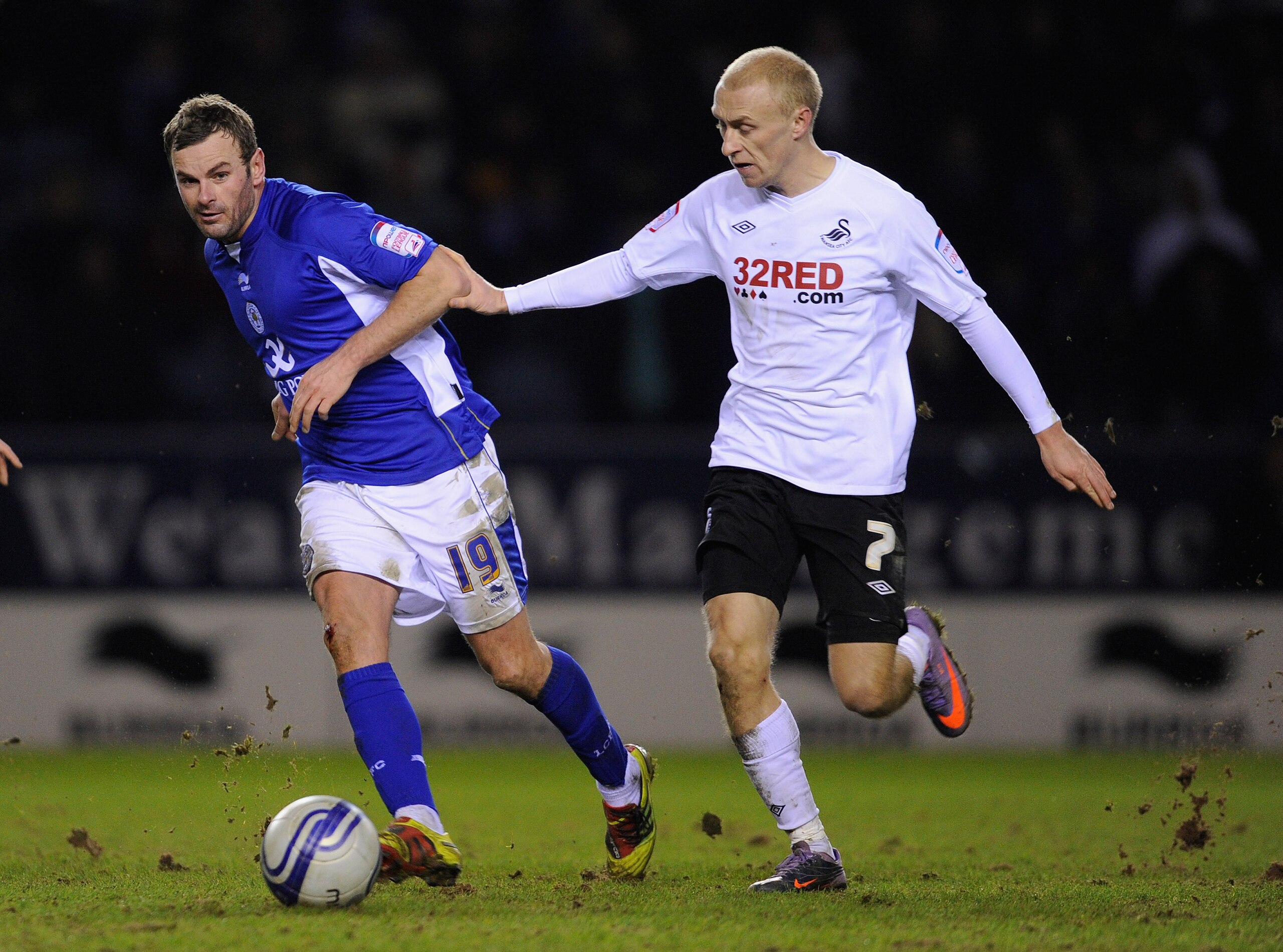 LEICESTER, ENGLAND - JANUARY 03: Richie Wellens of Leicester holds off David Cotterill of Swansea during the npower Championship match between Leicester City and Swansea City at the Walkers Stadium on January 3, 2011 in Leicester, England.  (Photo by Mich