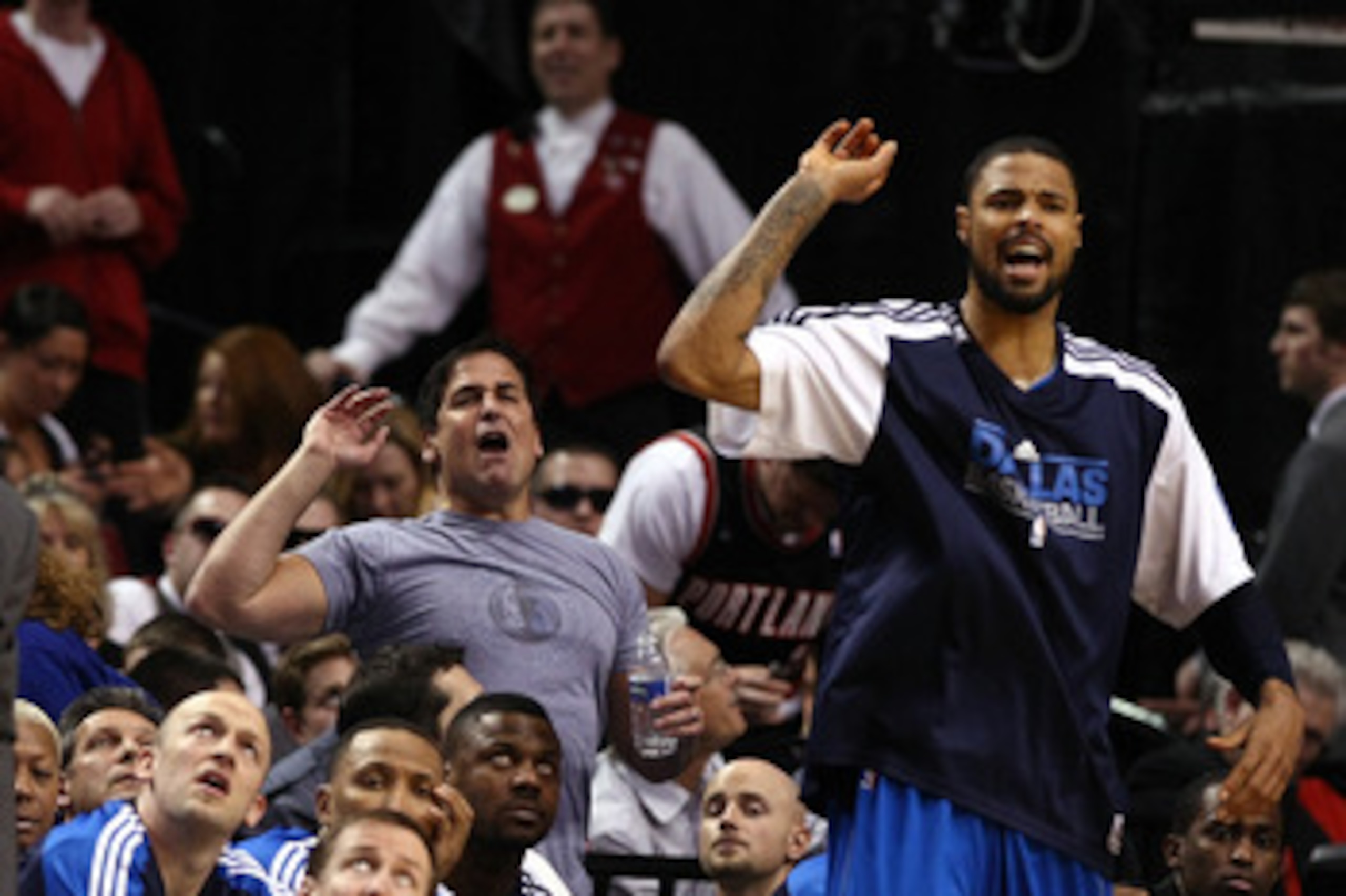PORTLAND, OR - APRIL 21:  Dallas Mavericks owner, Mark Cuban (C), Tyson Chandler #6 (R) and assistant coach  Dwayne Casey (L) call for a shooting foul against the Portland Trail Blazersin Game Three of the Western Conference Quarterfinals in the 2011 NBA 