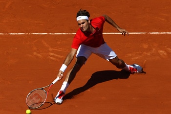 PARIS, FRANCE - MAY 23:  Roger Federer of Switzerland slides to play a forehand during the men's singles first round match between Feliciano Lopez of Spain and Roger Federer of Switzerland on day two of the French Open at Roland Garros on May 23, 2011 in