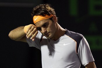 KEY BISCAYNE, FL - APRIL 01:  Roger Federer of Switzerland wipes sweat off of his forehead against Rafael Nadal of Spain during their men's semifinal match at the Sony Ericsson Open at Crandon Park Tennis Center on April 1, 2011 in Key Biscayne, Florida.