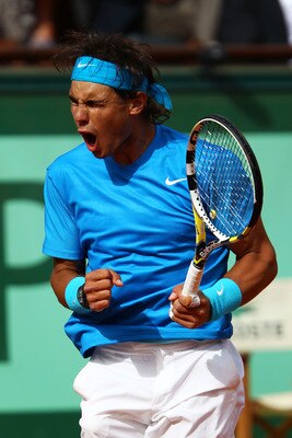PARIS, FRANCE - MAY 24:  Rafael Nadal of Spain celebrates a point during the men's singles round one match between Rafael Nadal of Spain and John Isner of USA on day three of the French Open at Roland Garros on May 24, 2011 in Paris, France.  (Photo by Cl