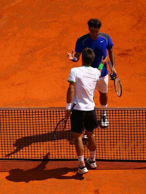 MONACO - APRIL 15:  Jurgen Melzer of Austria shakes hands with Roger Federer of Switzerland after Melzer won in straight sets during Day Six of the ATP Masters Series Tennis at the Monte Carlo Country Club on April 15, 2011 in Monte Carlo, Monaco.  (Photo