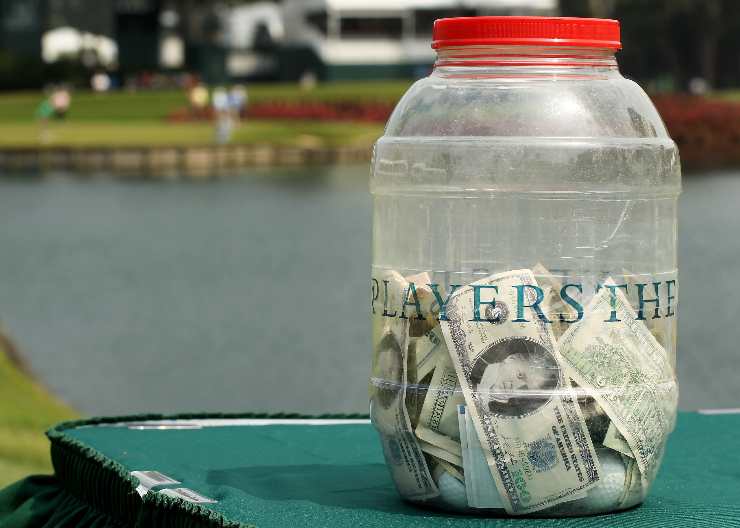 PONTE VEDRA BEACH, FL - MAY 11:  The money jar for the 'Caddie Challenge' is seen on the 17th hole during a practice round prior to the start of THE PLAYERS Championship held at THE PLAYERS Stadium course at TPC Sawgrass on May 11, 2011 in Ponte Vedra Bea