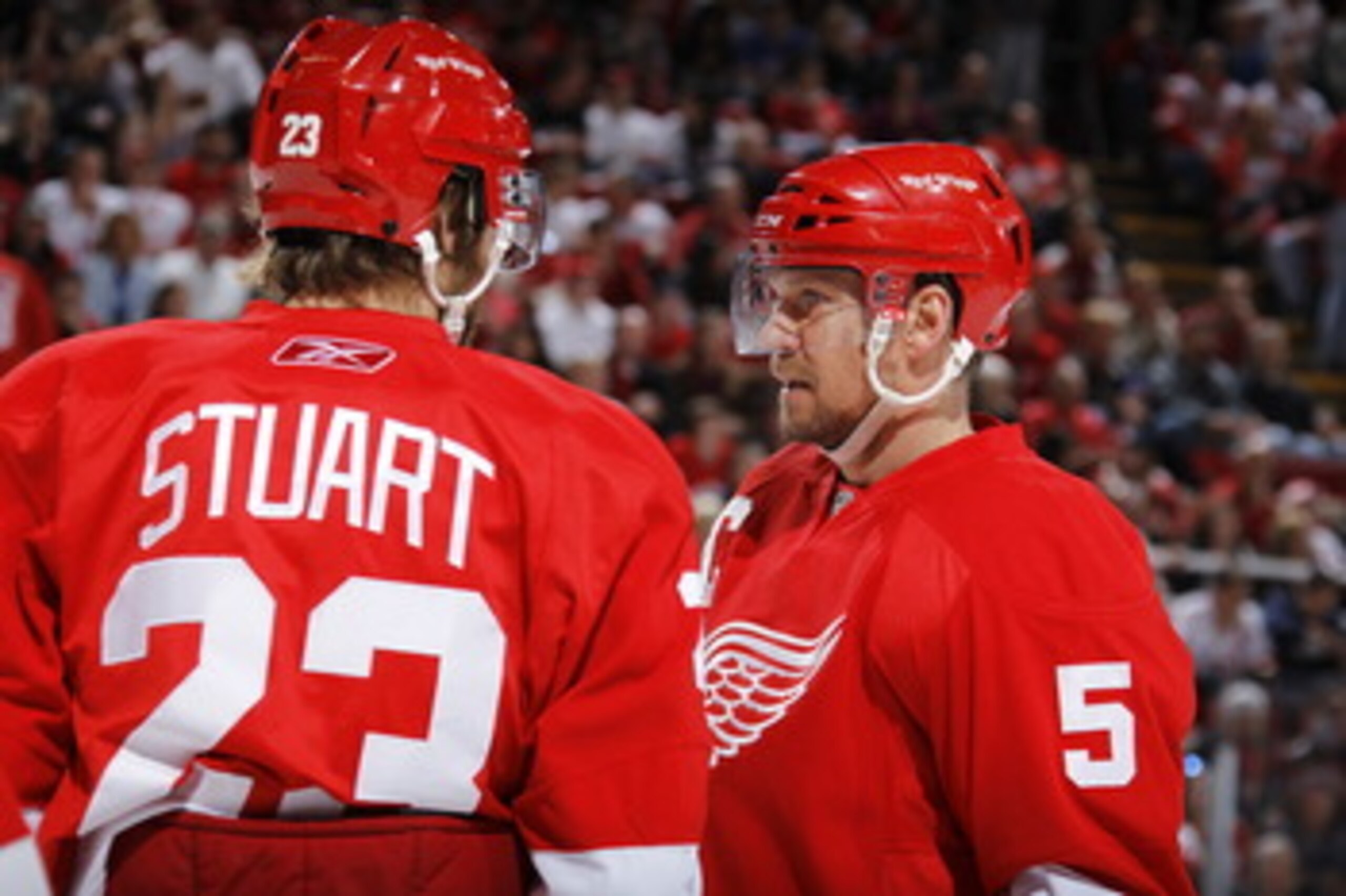 DETROIT - MAY 6: Brad Stuart #23 and Nicklas Lidstrom #5 of the Detroit Red Wings talk while playing the San Jose Sharks in Game Four of the Western Conference Semifinals during the 2011 NHL Stanley Cup Playoffs on May 6, 2011 at Joe Louis Arena in Detroi