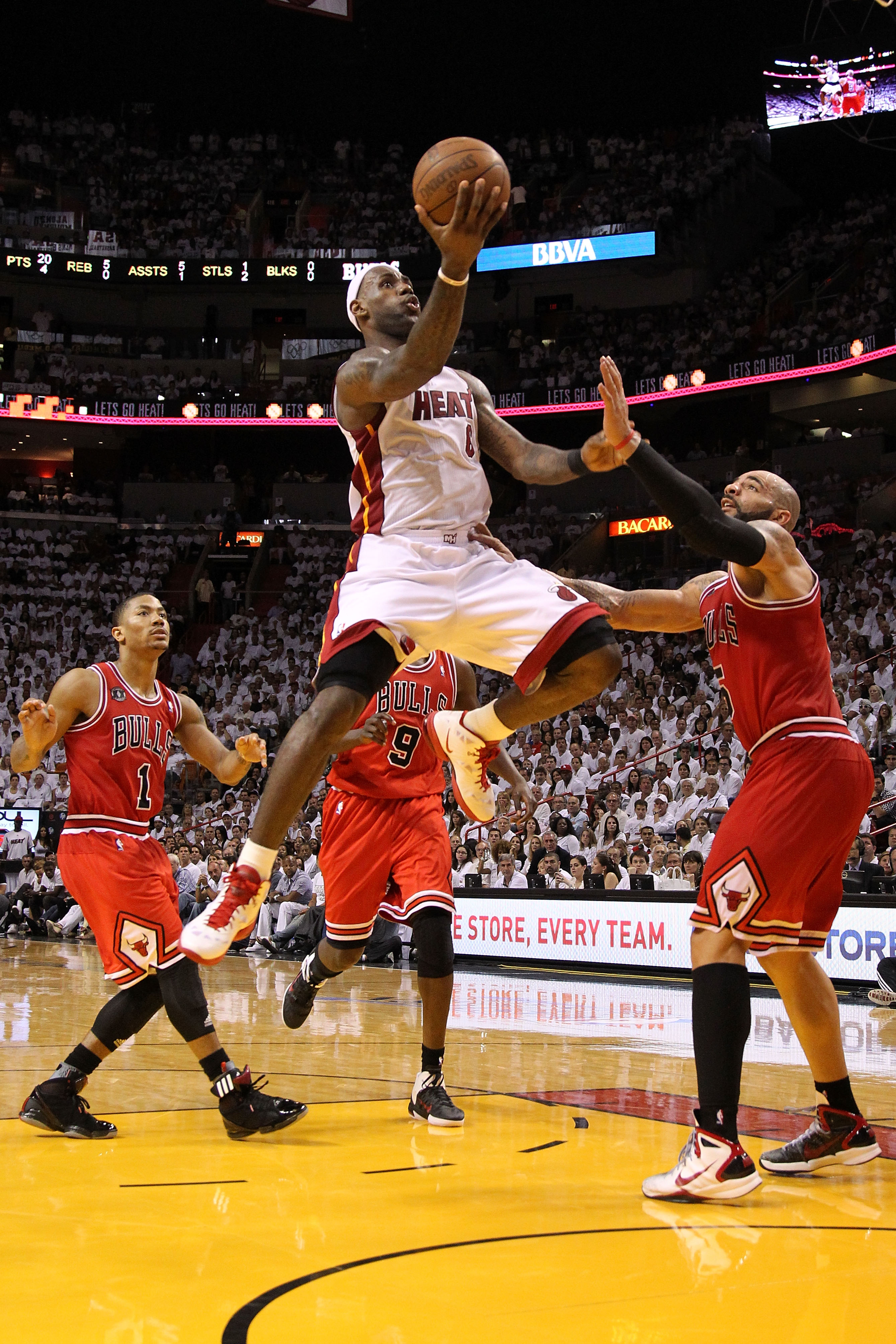 MIAMI, FL - MAY 22:  LeBron James #6 of the Miami Heat drives for a shot attempt against Carlos Boozer #5 and Derrick Rose #1 of the Chicago Bulls in Game Three of the Eastern Conference Finals during the 2011 NBA Playoffs on May 22, 2011 at American Airl