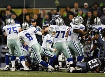 SEATTLE - JANUARY 06:  Quarterback Tony Romo #9 of the Dallas Cowboys picks up the fumbled snap on the game winning field goal attempt in the fourth quarter of the NFC Wild Card Playoff Game against the Seattle Seahawks on January 6, 2007 at Qwest Field i