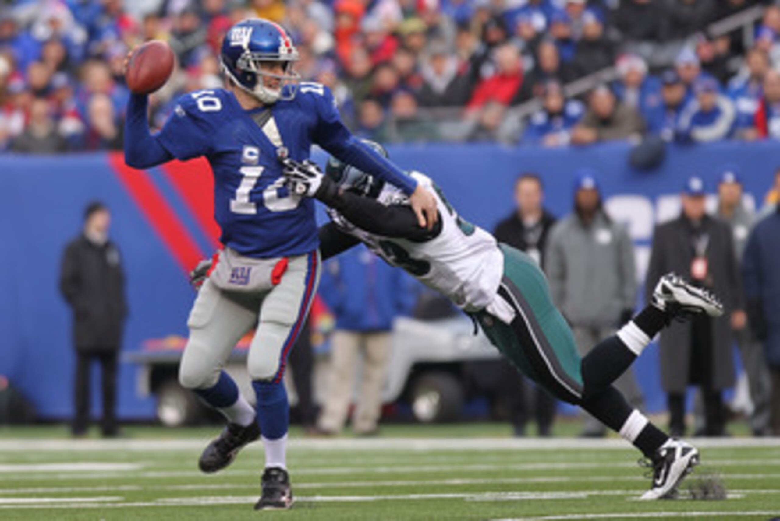 EAST RUTHERFORD, NJ - DECEMBER 19: Eli Manning #10 of the New York Giants is sacked by Moise Fokou #53 of the Philadelphia Eagles at New Meadowlands Stadium on December 19, 2010 in East Rutherford, New Jersey. (Photo by Nick Laham/Getty Images) EAST RUTHERFORD, NJ - DECEMBER 19: Eli Manning #10 of the New York Giants is sacked by Moise Fokou #53 of the Philadelphia Eagles at New Meadowlands Stadium on December 19, 2010 in East Rutherford, New Jersey. (Photo by Nick Laham/Getty Images)