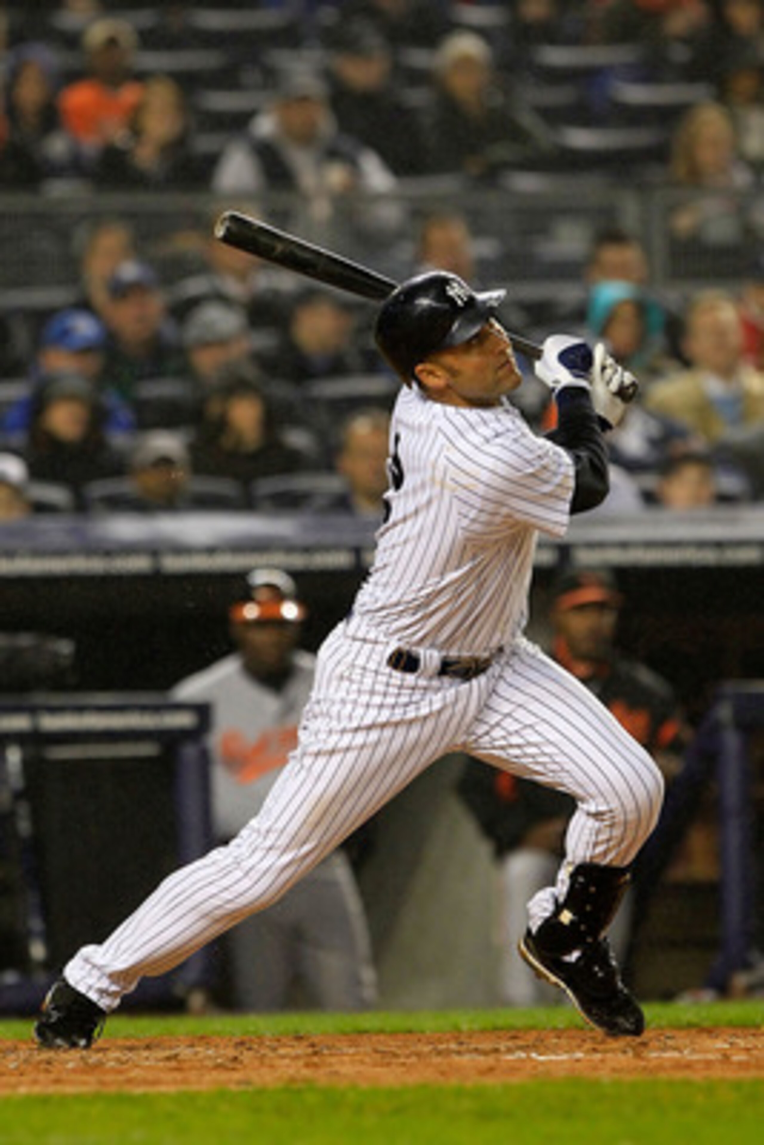 NEW YORK, NY - APRIL 13: Derek Jeter #2 of the New York Yankees hits an RBI single in the second inning against the Baltimore Orioles at Yankee Stadium on April 13, 2011 in the Bronx borough of New York City.  (Photo by Chris Trotman/Getty Images)