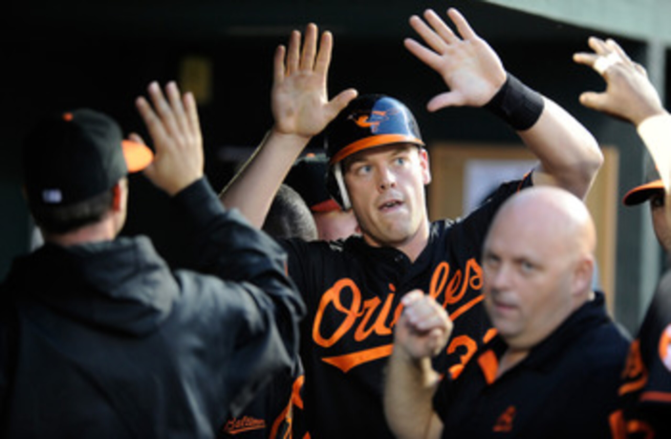 BALTIMORE, MD - MAY 20:  Matt Wieters #32 of the Baltimore Orioles celebrates with teammates after scoring in the third inning against the Washington Nationals at Oriole Park at Camden Yards on May 20, 2011 in Baltimore, Maryland.  (Photo by Greg Fiume/Ge