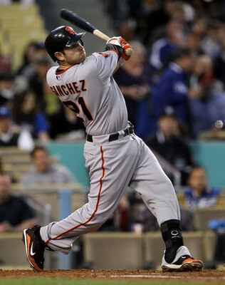 LOS ANGELES - MAY 18:  Freddy Sanchez #21 of the San Francisco Giants hits an RBI single in the third inning against the Los Angeles Dodgers on May 18, 2011 at Dodger Stadium in Los Angeles, California.  (Photo by Stephen Dunn/Getty Images)