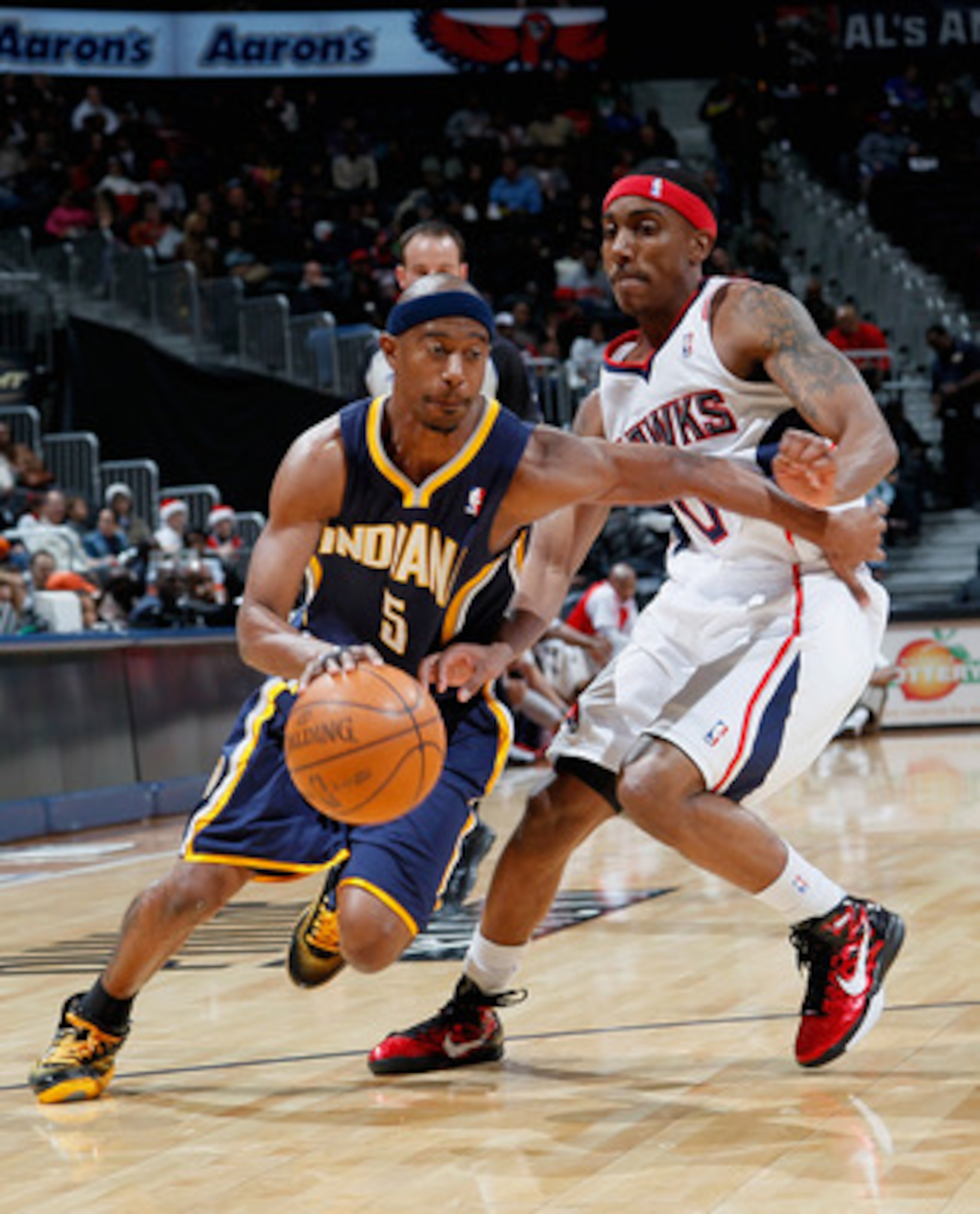 ATLANTA, GA - DECEMBER 11: T.J. Ford #5 of the Indiana Pacers drives past Jeff Teague #0 of the Atlanta Hawks at Philips Arena on December 11, 2010 in Atlanta, Georgia. NOTE TO USER: User expressly acknowledges and agrees that, by downloading and/or usi ATLANTA, GA - DECEMBER 11: T.J. Ford #5 of the Indiana Pacers drives past Jeff Teague #0 of the Atlanta Hawks at Philips Arena on December 11, 2010 in Atlanta, Georgia. NOTE TO USER: User expressly acknowledges and agrees that, by downloading and/or usi