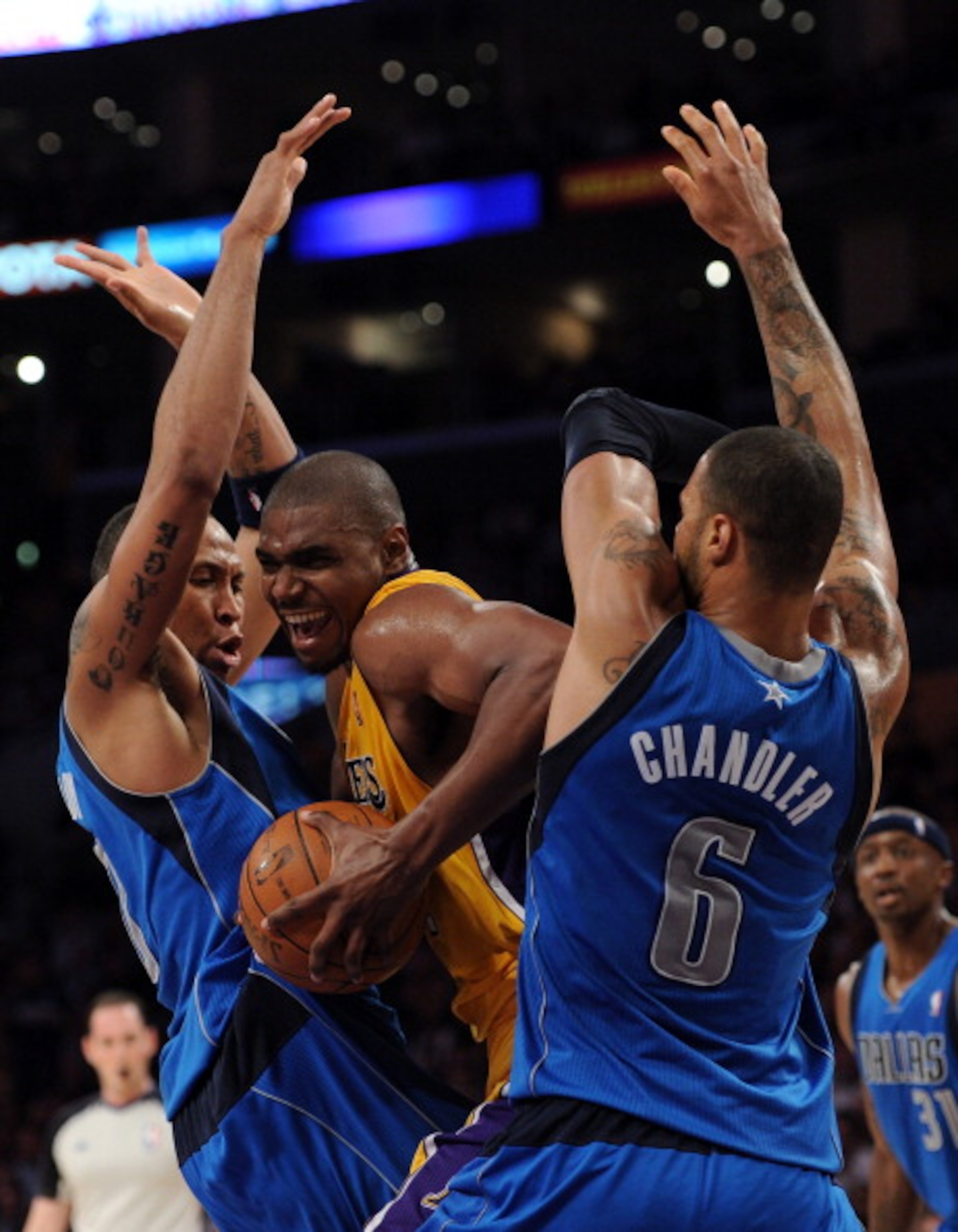 LOS ANGELES, CA - MARCH 31:  Andrew Bynum #17 of the Los Angeles Lakers attempts to split the defense of Shawn Marion #0 and Tyson Chandler #6 of the Dallas Mavericks at Staples Center on March 31, 2011 in Los Angeles, California.  NOTE TO USER: User expr