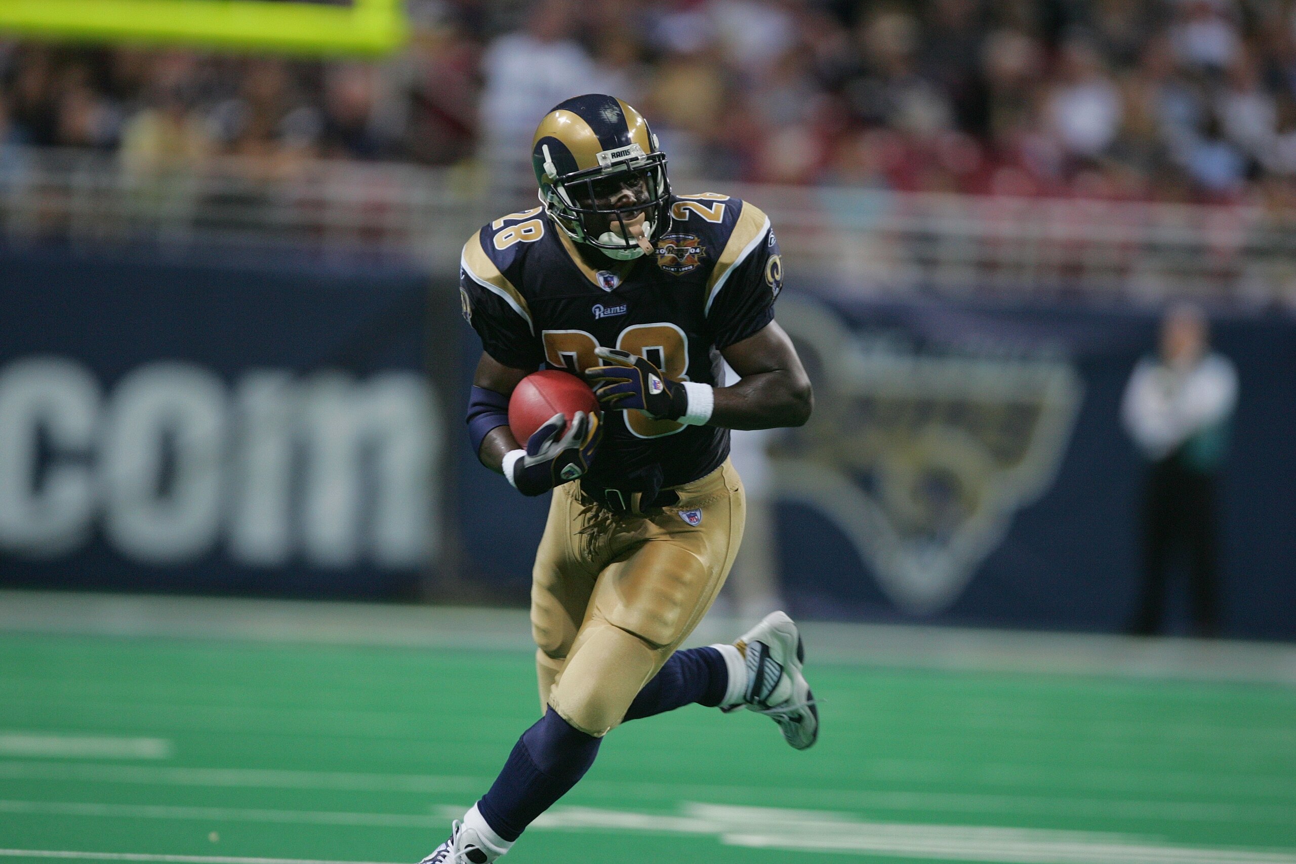 ST. LOUIS - SEPTEMBER 26:  Running back Marshall Faulk #28 of the St. Louis Rams carries the ball against the New Orleans Saints during the game at the Edward Jones Dome on September 26, 2004 in St. Louis, Missouri. Saints defeated the Rams 28-25 in overt