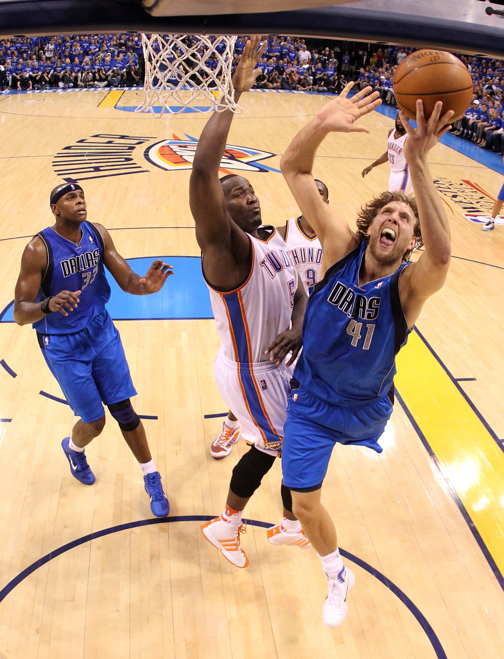 OKLAHOMA CITY, OK - MAY 23:  Dirk Nowitzki #41 of the Dallas Mavericks goes up for a shot against Kendrick Perkins #5 of the Oklahoma City Thunder in the first half in Game Four of the Western Conference Finals during the 2011 NBA Playoffs at Oklahoma Cit