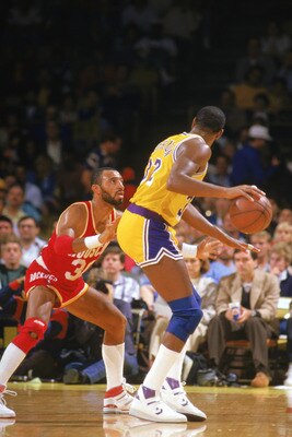 INGLEWOOD -1987:  Allan Leavell #30 of the Houston Rockets guards Magic Johnson #32 of the Los Angeles Lakers during a game in the 1987-88 season at the Forum in Inglewood, California. NOTE TO USER: User expressly acknowledges and agrees that, by download