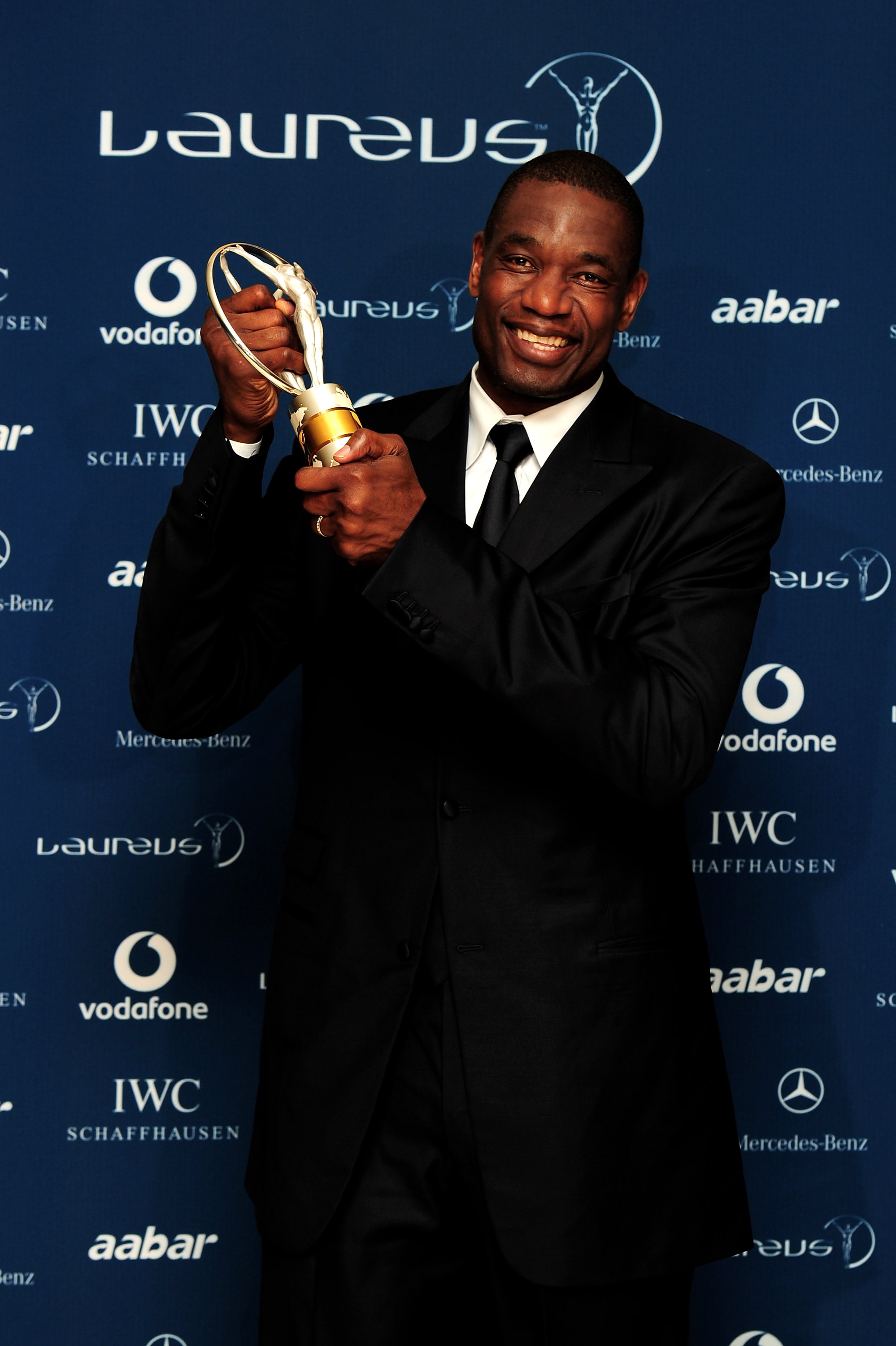 ABU DHABI, UNITED ARAB EMIRATES - MARCH 10:  US basketball legend Dikembe Mutombo poses with his award for 'Sport For Good '  in the Awards room during the Laureus World Sports Awards 2010 at Emirates Palace Hotel on March 10, 2010 in Abu Dhabi, United Ar