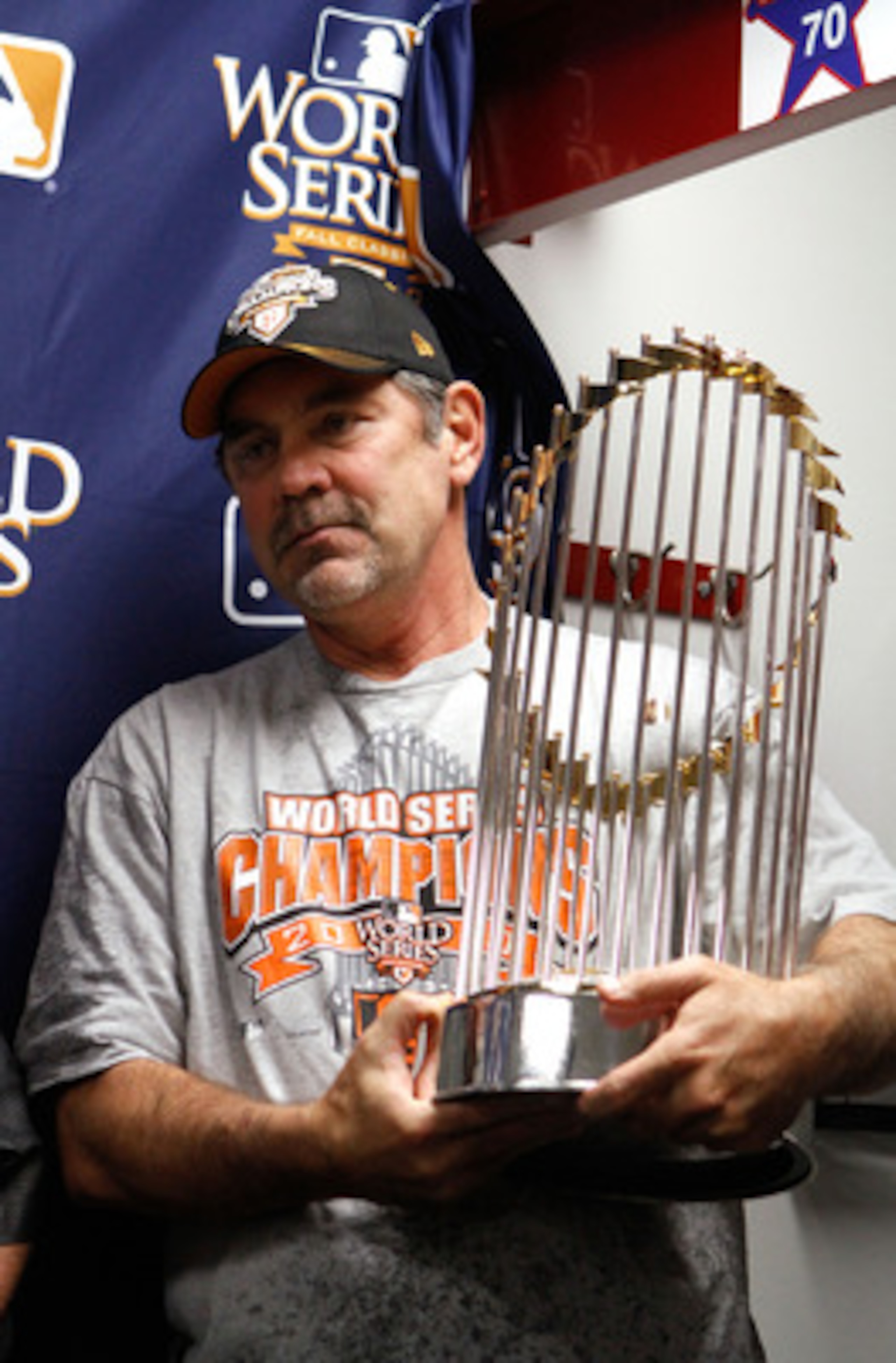 ARLINGTON, TX - NOVEMBER 01:  Manager Bruce Bochy of the San Francisco Giants celebrates with the World Series trophy in the locker room after the Giants won 3-1 against the Texas Rangers in Game Five of the 2010 MLB World Series at Rangers Ballpark in Ar