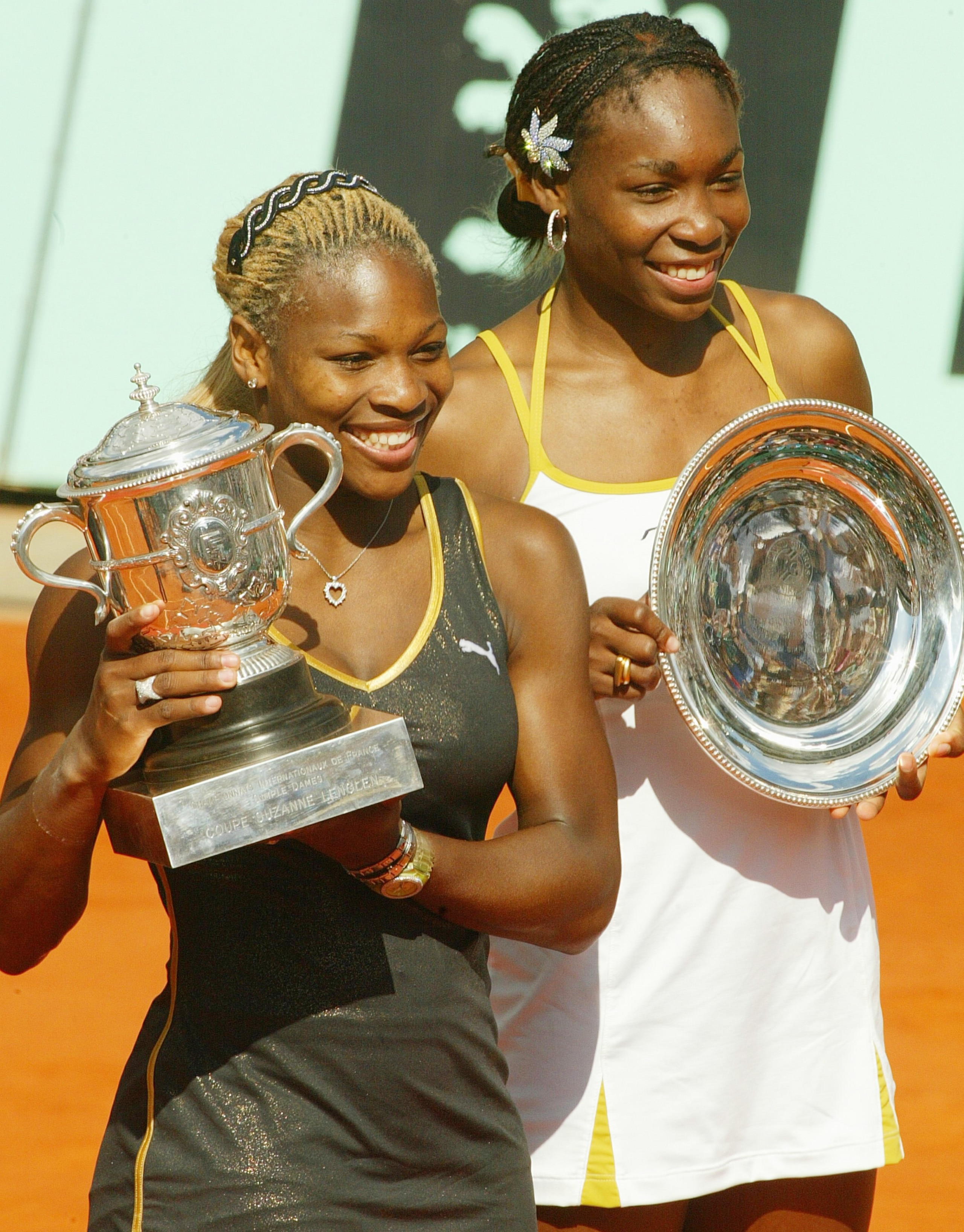 PARIS - JUNE 8: Serena Williams (left) and sister Venus of the USA pose with thire trophies after the French Open final on June 8, 2002 at the Roland Garros stadium in Paris, France. Serena deated Venus 7-5 6-3. (Photo by Pascal Le Segretain/Getty Images)