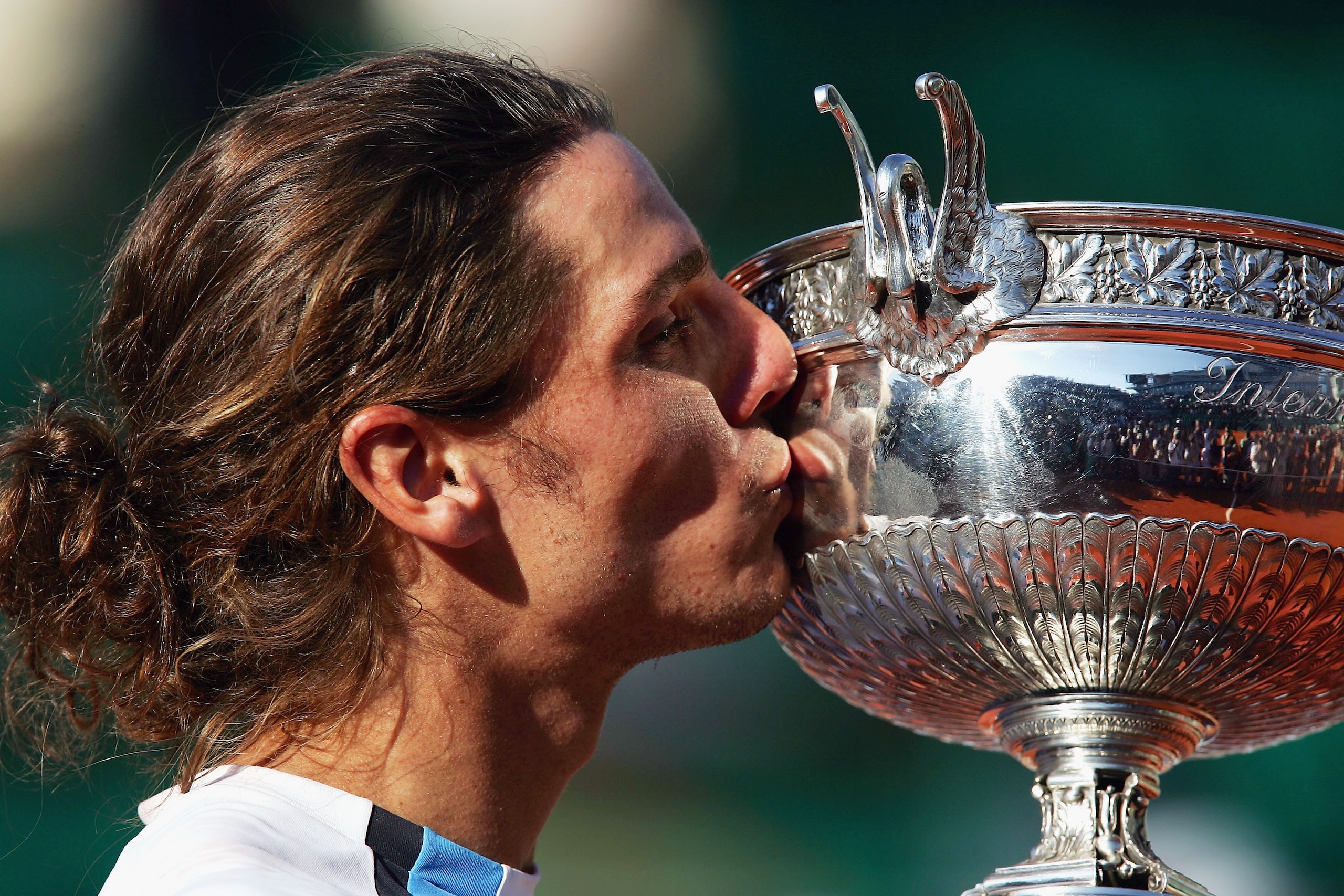 PARIS - JUNE 6: Gaston Gaudio of Argentina celebrates with the trophy after winning his mens final match against Guillermo Coria of Argentina, on Day Fourteen of the 2004 French Open Tennis Championship at Roland Garros on June 6, 2004 in Paris, France. (