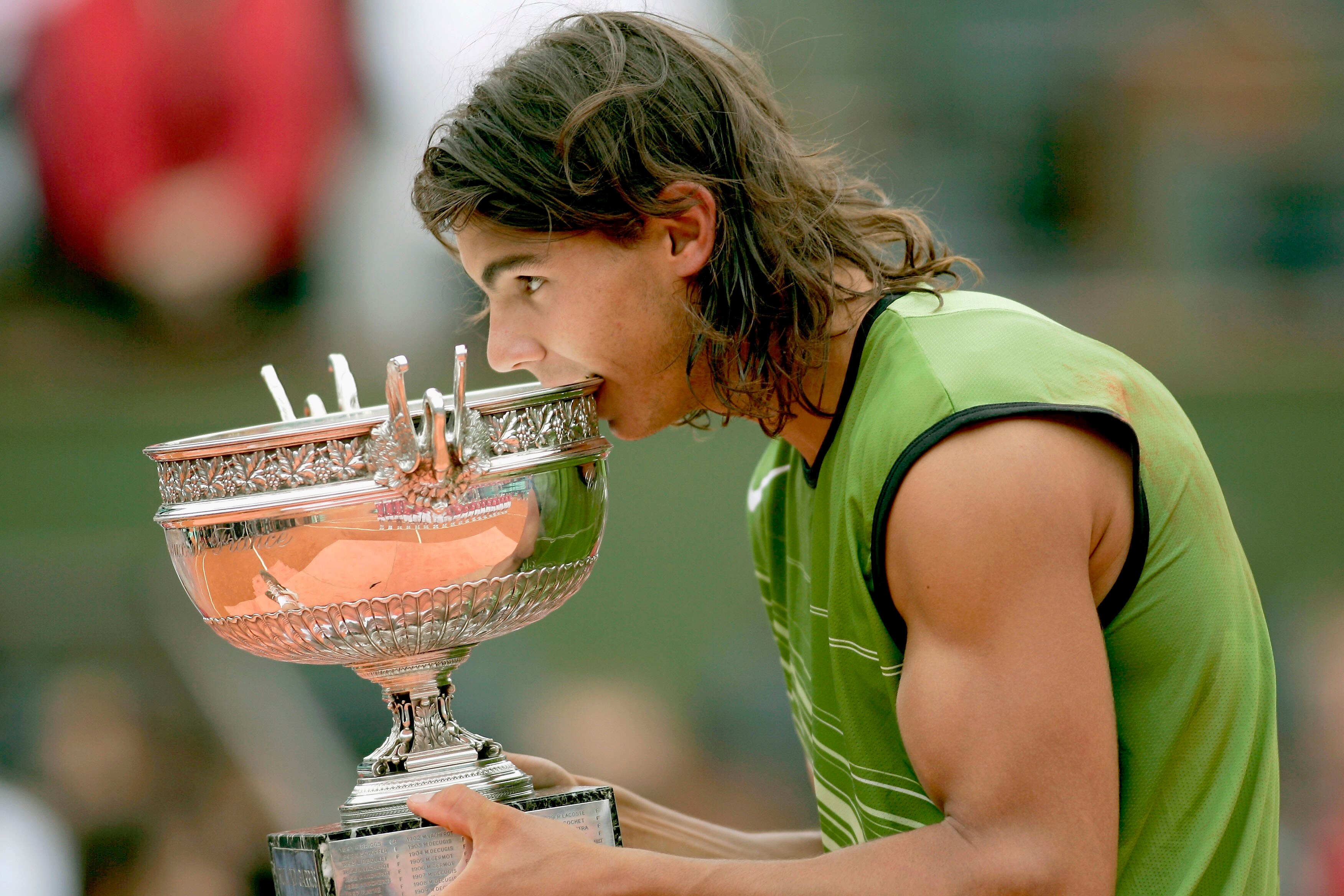 PARIS - JUNE 05: Rafael Nadal of Spain poses with the winners trophy after his 3-1 sets victory over Mariano Puerta of Argentina during the Mens Final match during the fourteenth day of the French Open at Roland Garros on June 5, 2005 in Paris, France. PARIS - JUNE 05: Rafael Nadal of Spain poses with the winners trophy after his 3-1 sets victory over Mariano Puerta of Argentina during the Mens Final match during the fourteenth day of the French Open at Roland Garros on June 5, 2005 in Paris, France.