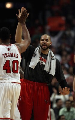 CHICAGO, IL - APRIL 13: Carlos Boozer #5 of the Chicago Bulls greets teammate Kurt Thomas #40 during a time-out against the New Jersey Nets at the United Center on April 13, 2011 in Chicago, Illinois. The Bulls defeated the Nets 97-92. NOTE TO USER: User 