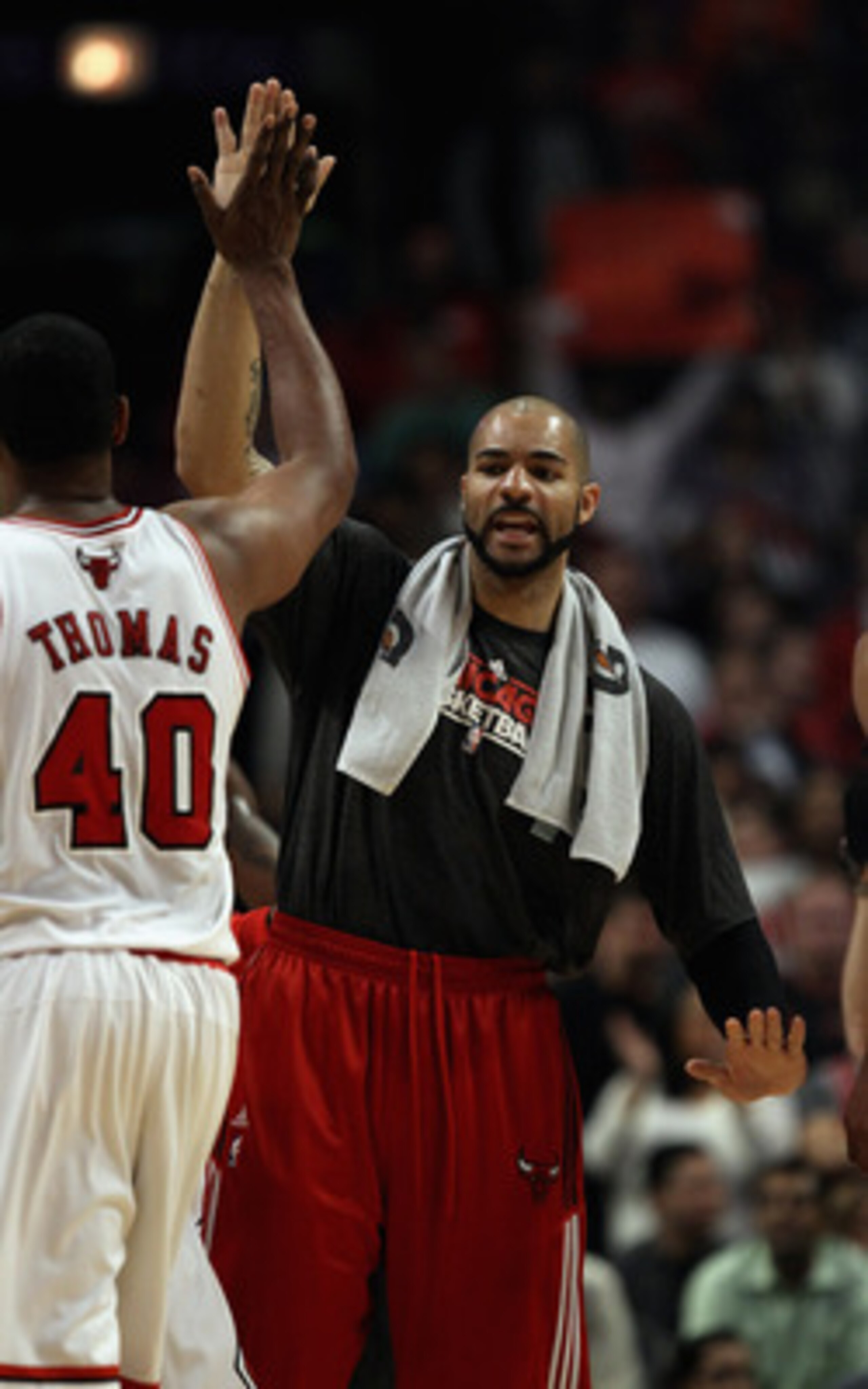 CHICAGO, IL - APRIL 13: Carlos Boozer #5 of the Chicago Bulls greets teammate Kurt Thomas #40 during a time-out against the New Jersey Nets at the United Center on April 13, 2011 in Chicago, Illinois. The Bulls defeated the Nets 97-92. NOTE TO USER: User 