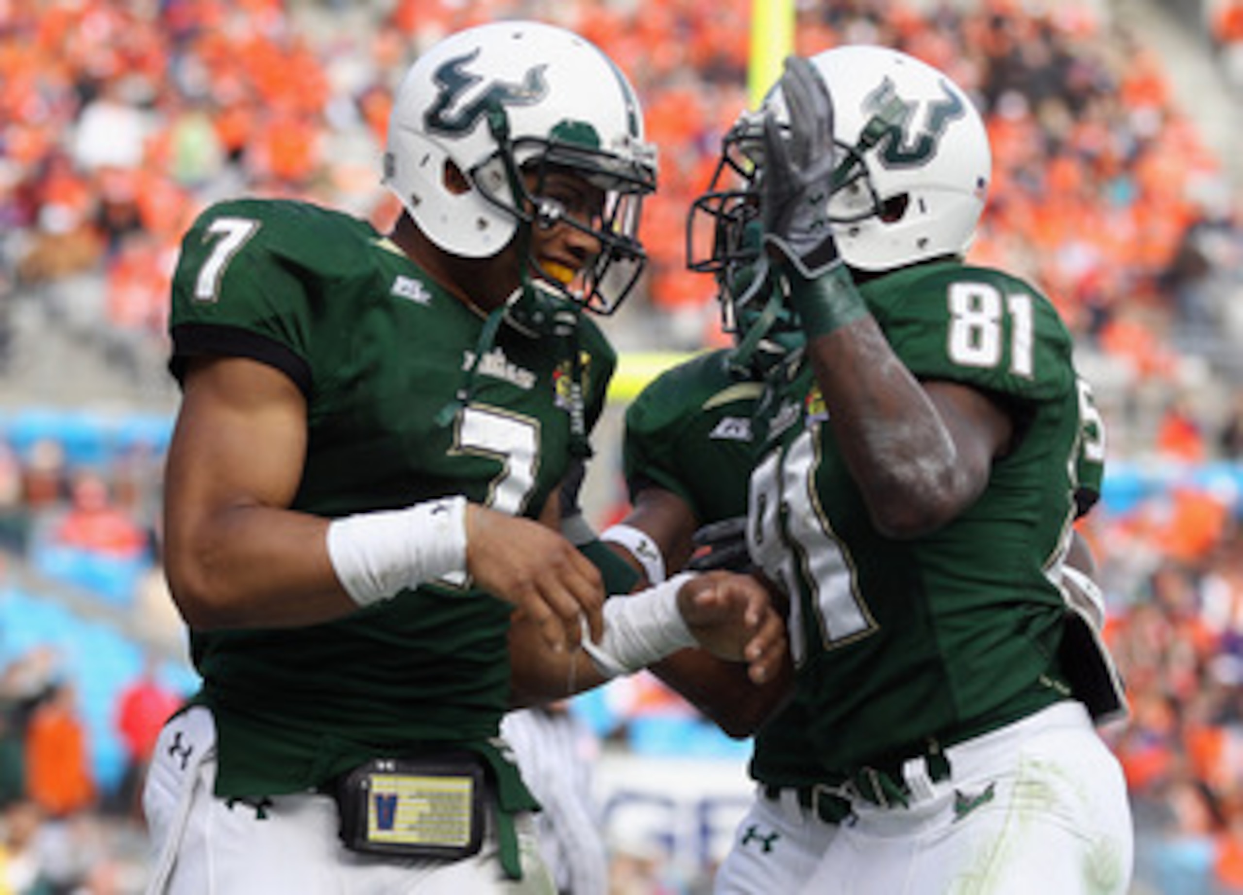 CHARLOTTE, NC - DECEMBER 31: B.J. Daniels #7 of the USF Bulls celebrates after scoring a touchdown with teammate Dontavia Bogan #81 against the Clemson Tigers during their game at Bank of America Stadium on December 31, 2010 in Charlotte, North Carolina. CHARLOTTE, NC - DECEMBER 31: B.J. Daniels #7 of the USF Bulls celebrates after scoring a touchdown with teammate Dontavia Bogan #81 against the Clemson Tigers during their game at Bank of America Stadium on December 31, 2010 in Charlotte, North Carolina.