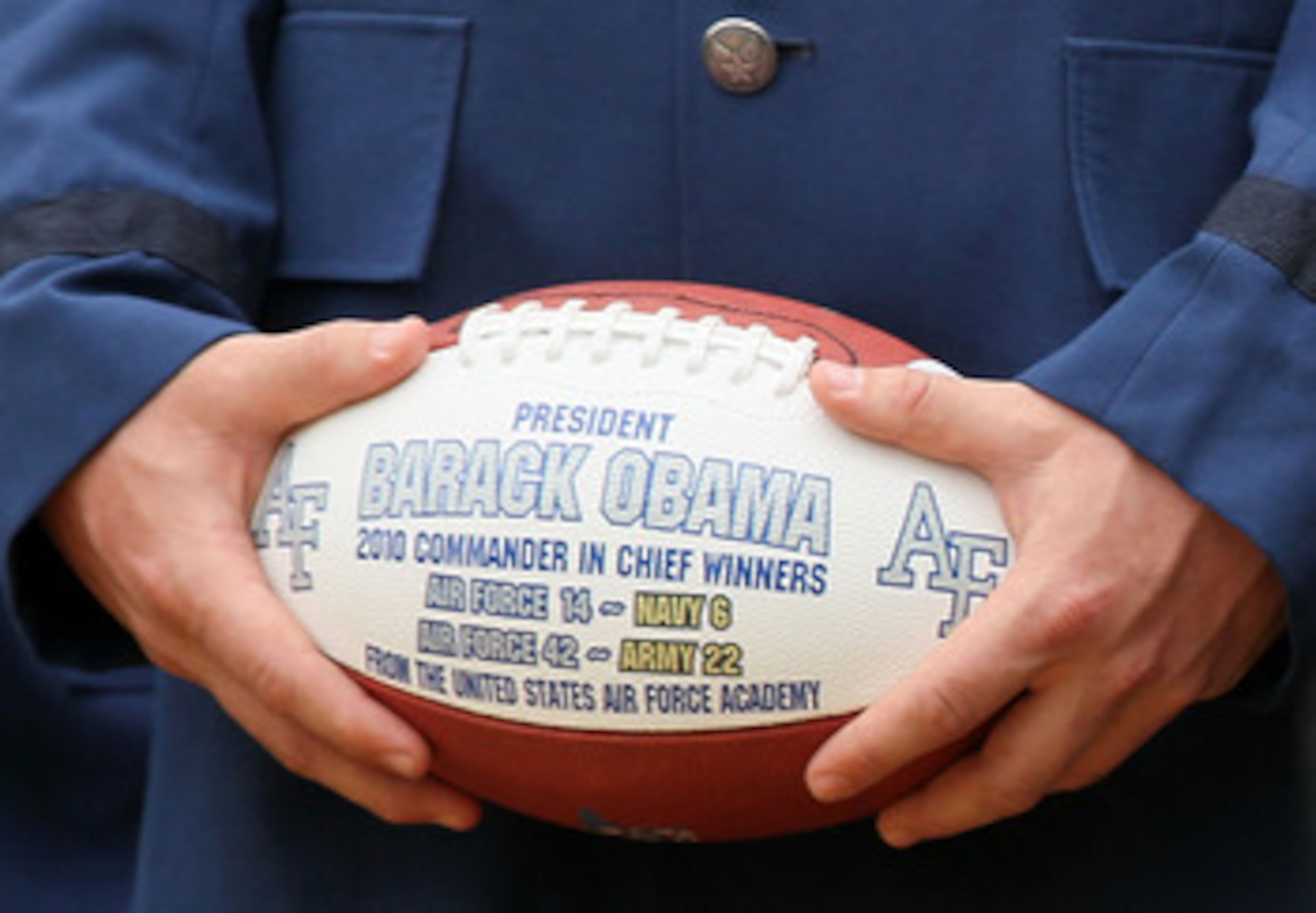 WASHINGTON - APRIL 18: Fullback Jared Tew holds a football as U.S. President Barack Obama hosts the Air Force Academy football team at the Rose Garden April 18, 2011 at the White House in Washington, DC. President Obama hosted the Air Force Academy footb WASHINGTON - APRIL 18: Fullback Jared Tew holds a football as U.S. President Barack Obama hosts the Air Force Academy football team at the Rose Garden April 18, 2011 at the White House in Washington, DC. President Obama hosted the Air Force Academy footb