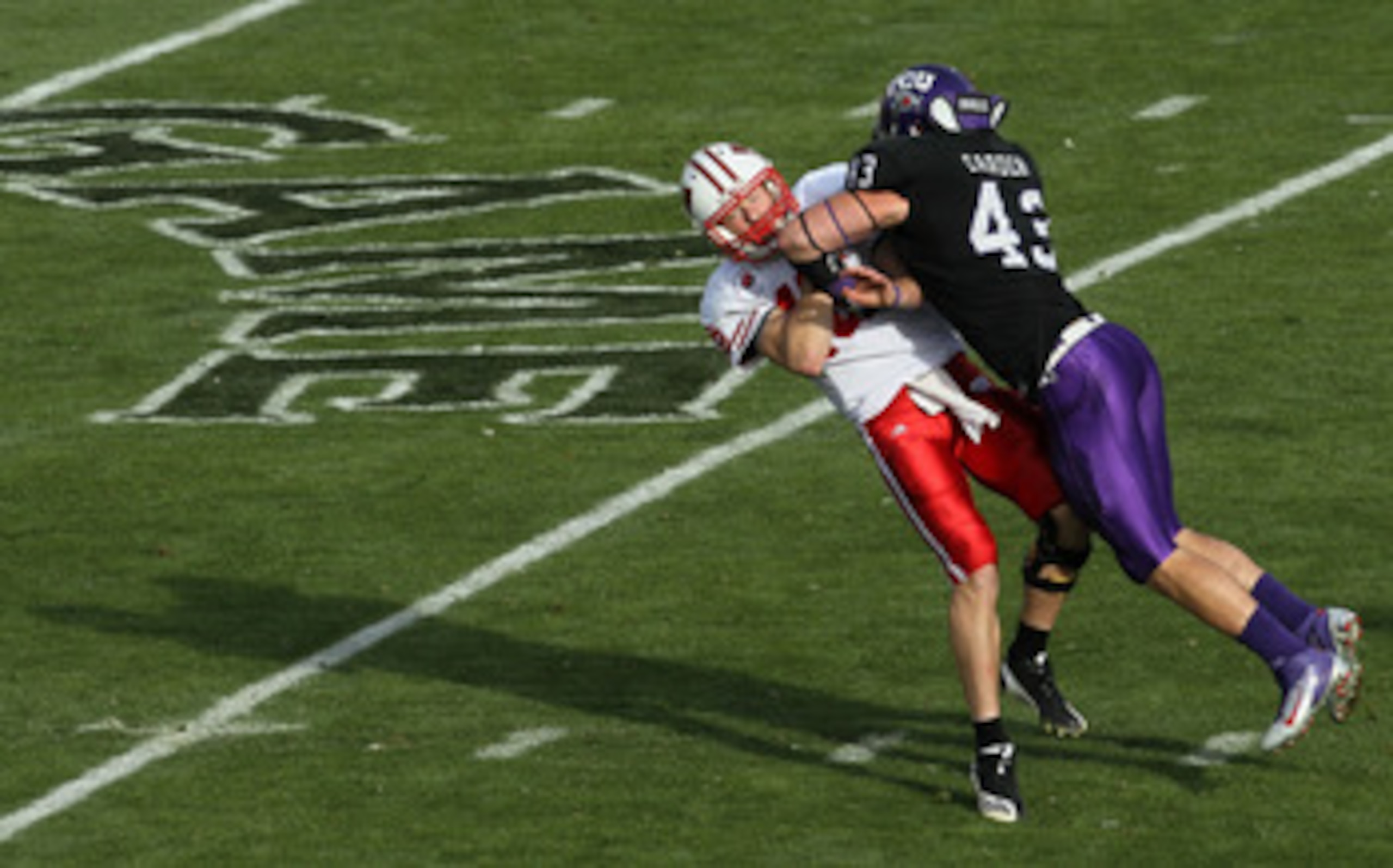 PASADENA, CA - JANUARY 01: Quarterback Scott Tolzien #16 of the Wisconsin Badgers is hit by linebacker Tank Carder #43 of the TCU Horned Frogs during the 97th Rose Bowl game on January 1, 2011 in Pasadena, California. (Photo by Stephen Dunn/Getty Images PASADENA, CA - JANUARY 01: Quarterback Scott Tolzien #16 of the Wisconsin Badgers is hit by linebacker Tank Carder #43 of the TCU Horned Frogs during the 97th Rose Bowl game on January 1, 2011 in Pasadena, California. (Photo by Stephen Dunn/Getty Images
