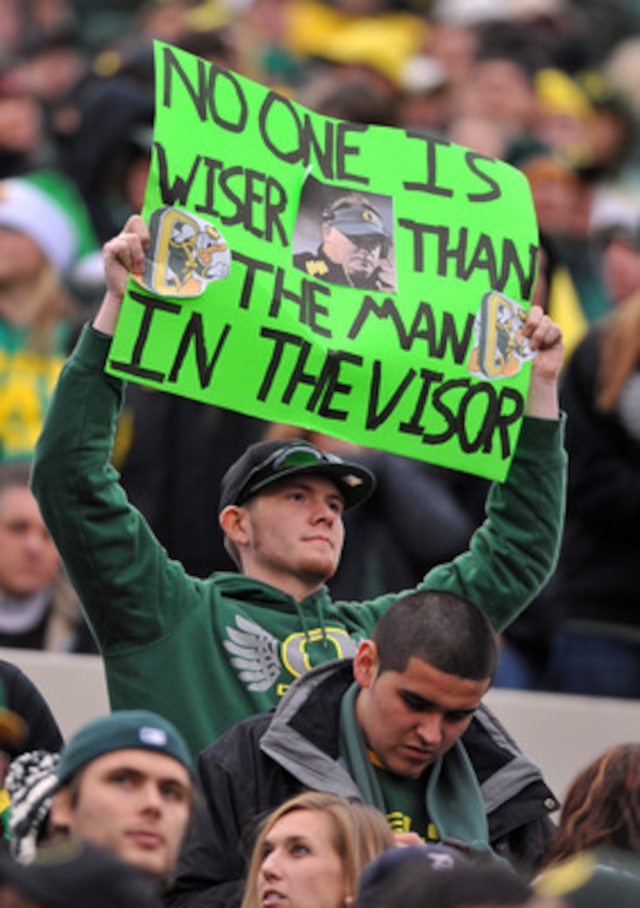 CORVALLIS, OR - DECEMBER 4: An Oregon Ducks fan holds up a sign featuring head coach Chip Kelly of the Oregon Ducks in the fourth quarter of the game against the the Oregon State Beavers at Reser Stadium on December 4, 2010 in Corvallis, Oregon. The Ducks CORVALLIS, OR - DECEMBER 4: An Oregon Ducks fan holds up a sign featuring head coach Chip Kelly of the Oregon Ducks in the fourth quarter of the game against the the Oregon State Beavers at Reser Stadium on December 4, 2010 in Corvallis, Oregon. The Ducks