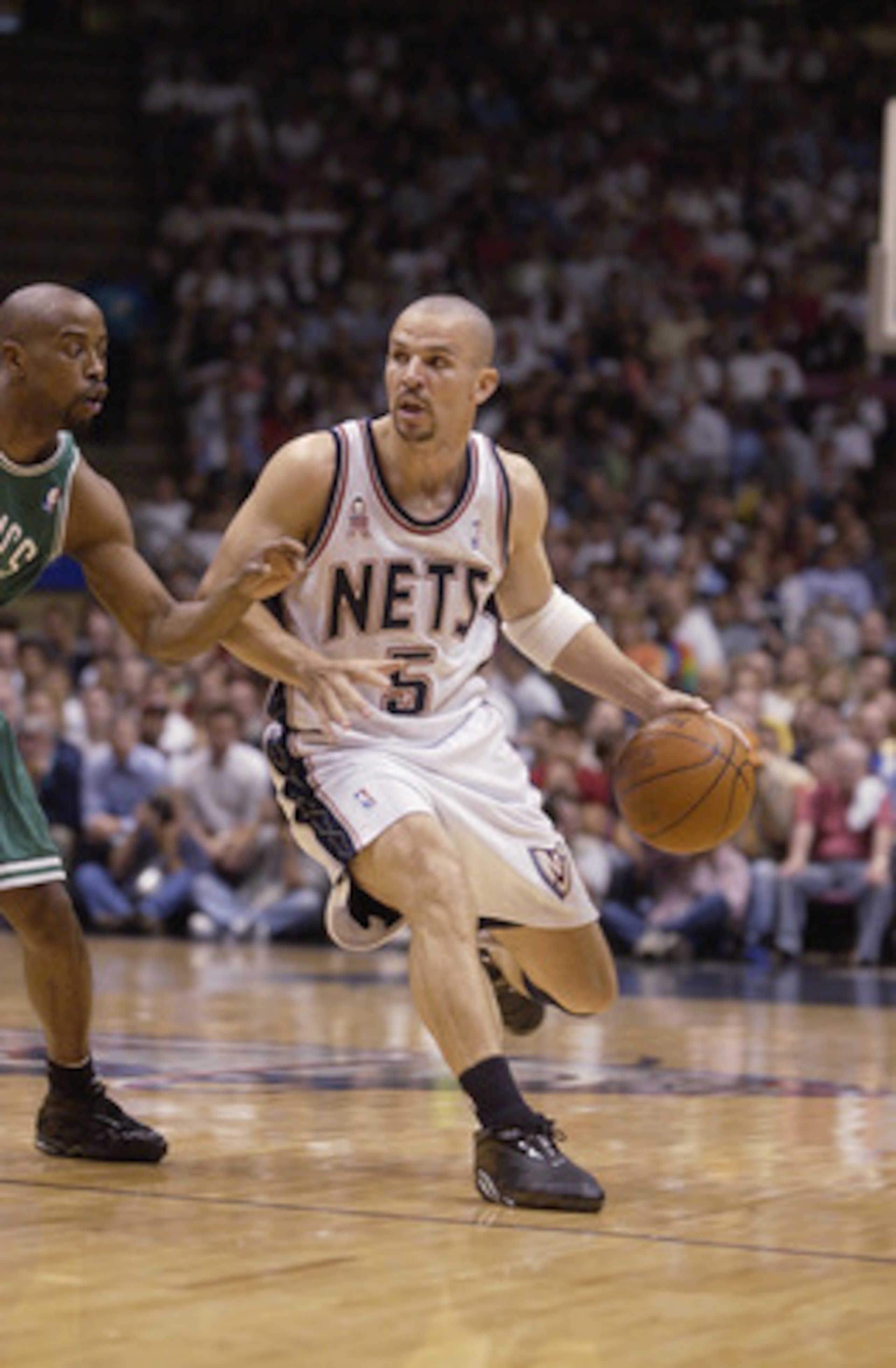 EAST RUTHERFORD, NJ - MAY 29:  Point guard Jason Kidd #5 of the New Jersey Nets drives past point guard Kenny Anderson #7 of the Boston Celtics in Game five of the Eastern Conference Finals during the 2002 NBA Playoffs at Continental Airlines Arena in Eas