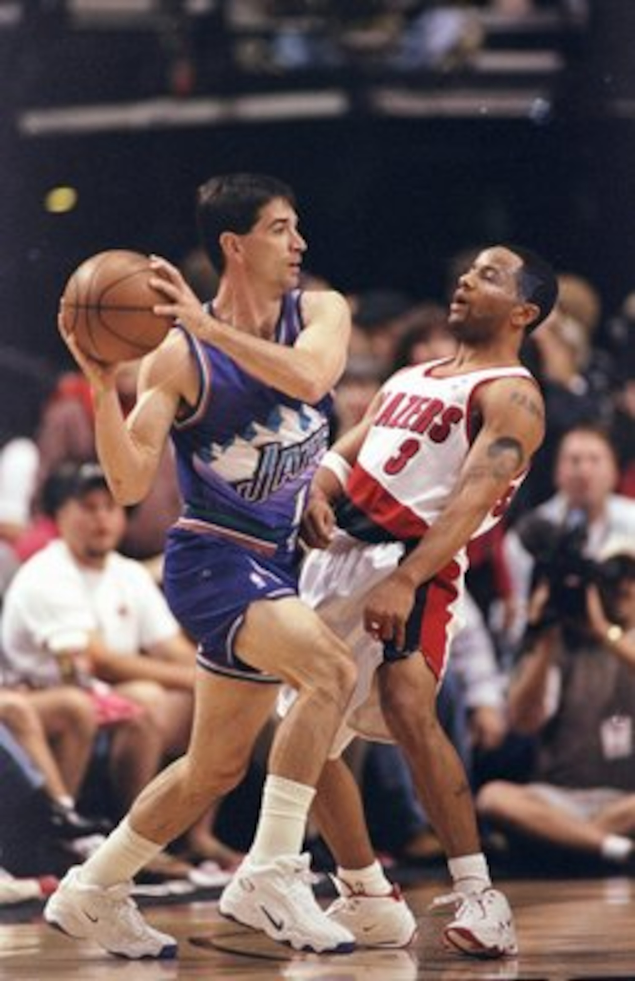 22 May 1999:  John Stockton #12 of the Utah Jazz moves with the ball around Damon Stoudamire #3 of the Portland Trail Blazers during game three of the NBA Western Conference Semifinals at the Rose Garden in Portland, Oregon. The Trail Blazers defeated the