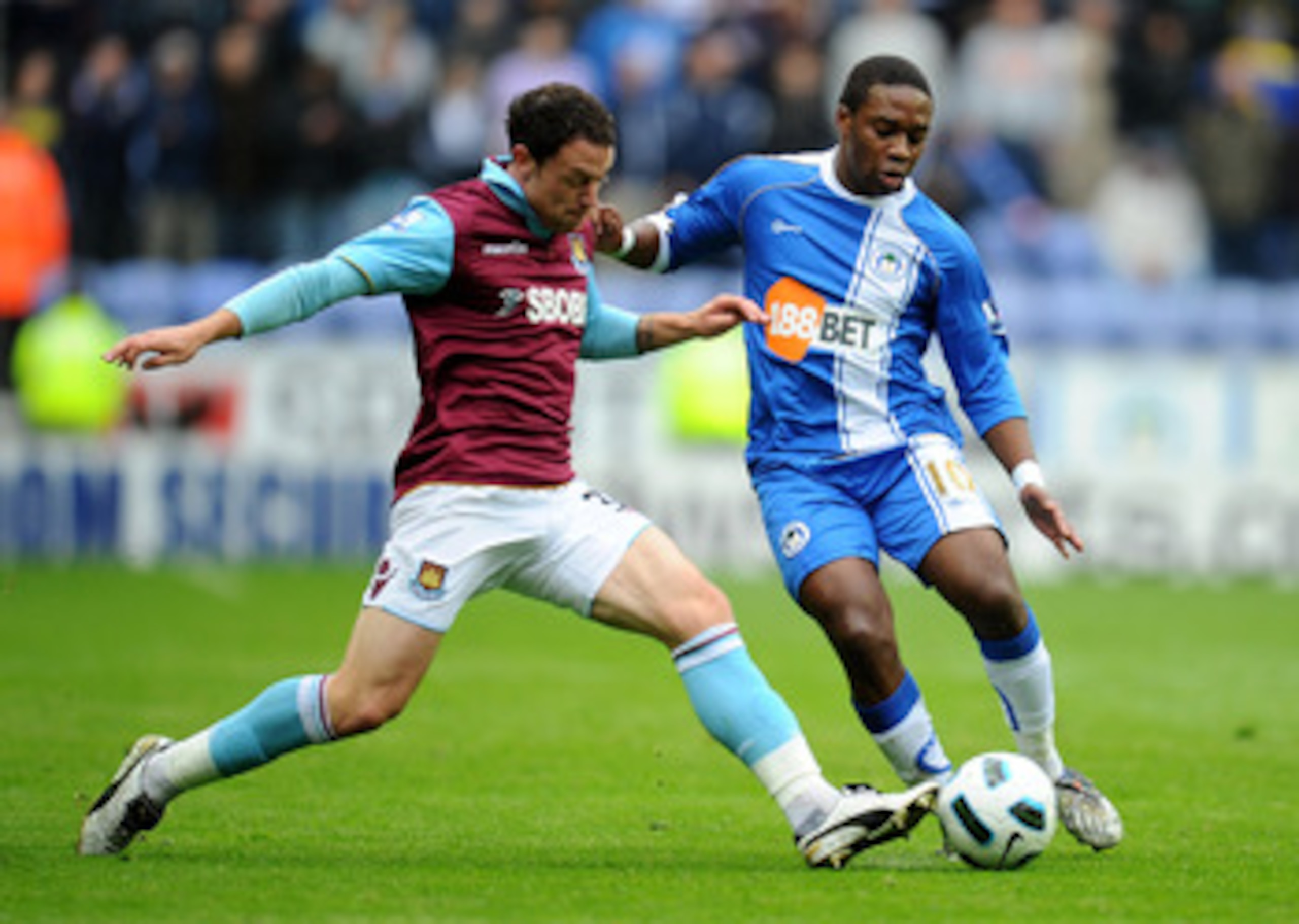 WIGAN, ENGLAND - MAY 15:  Charles N'Zogbia of Wigan Athletic is challenged by Wayne Bridge of West Ham United during the Barclays Premier League match between Wigan Athletic and West Ham United at the DW Stadium on May 15, 2011 in Wigan, England. (Photo b