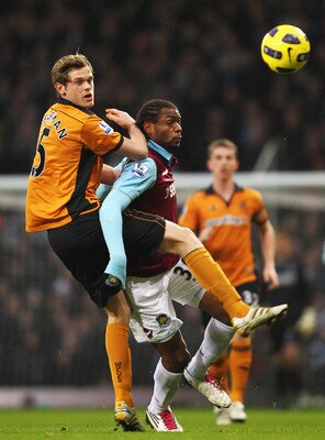 LONDON, ENGLAND - JANUARY 01: Richard Stearman of Wolverhampton Wanderers challenges Frederic Piquionne of West Ham United during the Barclays Premier League match between West Ham United and Wolverhampton Wanderers at the Boleyn Ground on January 1, 2011