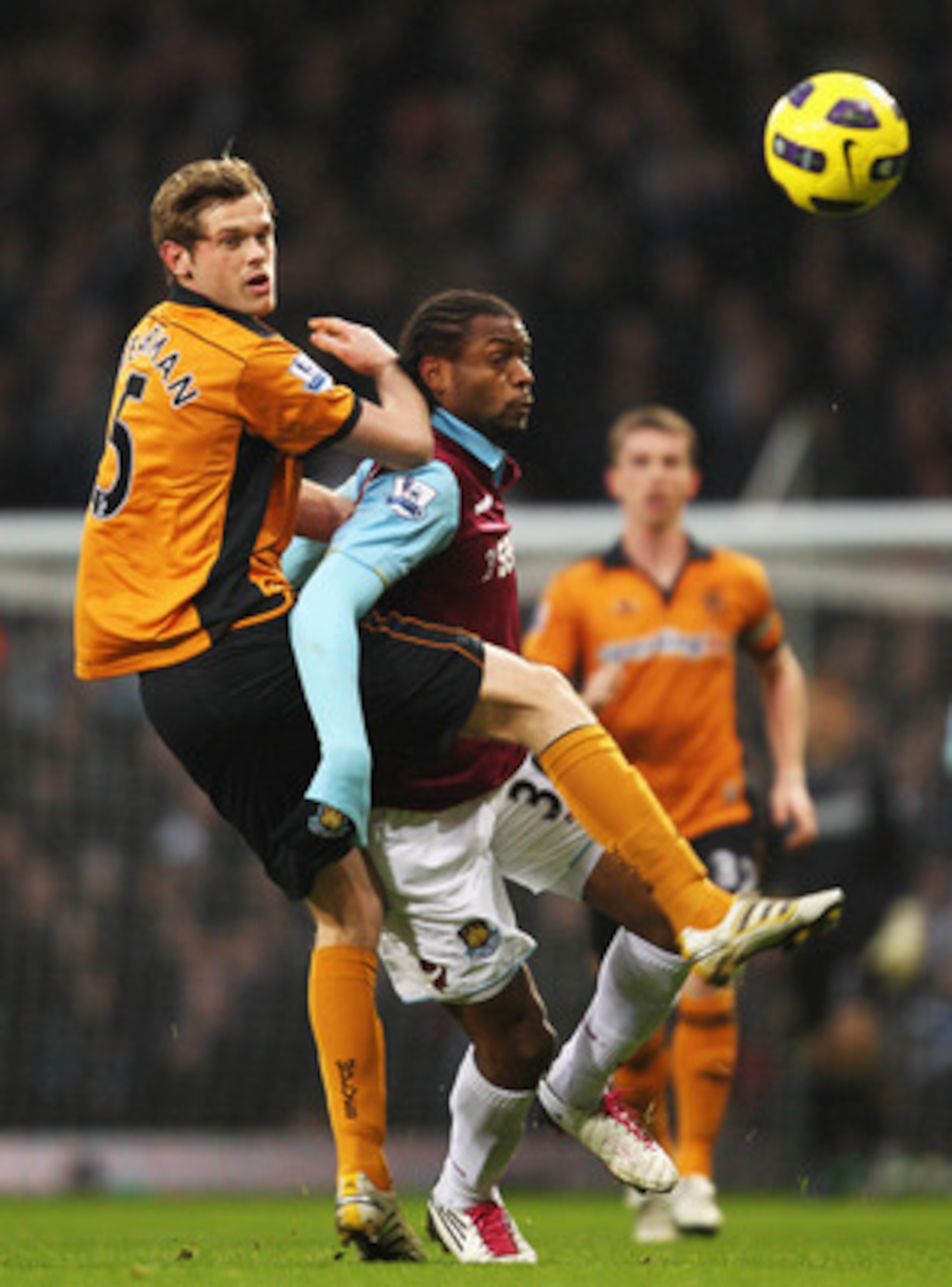 LONDON, ENGLAND - JANUARY 01: Richard Stearman of Wolverhampton Wanderers challenges Frederic Piquionne of West Ham United during the Barclays Premier League match between West Ham United and Wolverhampton Wanderers at the Boleyn Ground on January 1, 2011