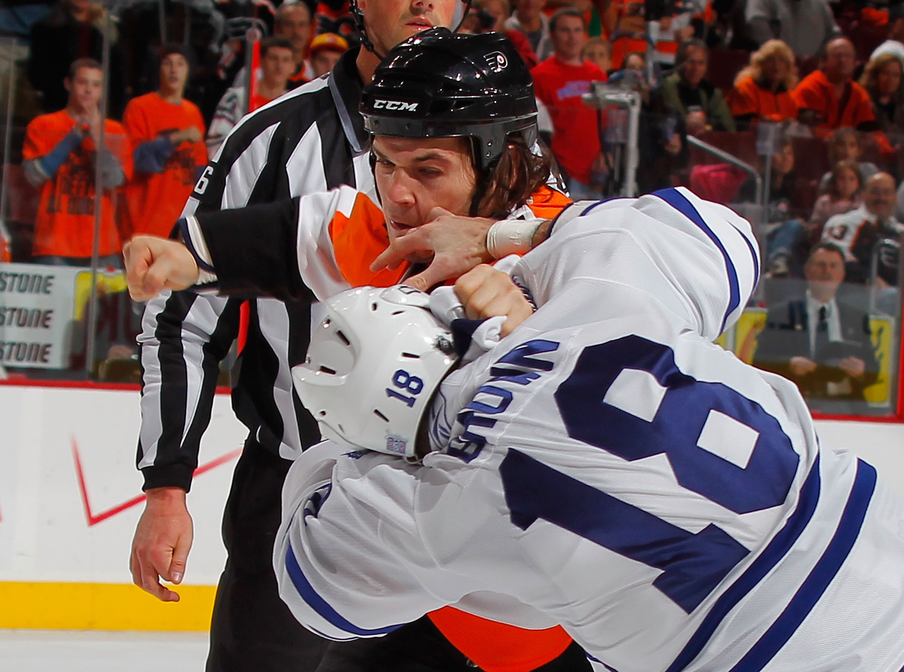PHILADELPHIA - OCTOBER 23:  Mike Brown #18 of the Toronto Maple Leafs fights with Daniel Carcillo #13 of the Philadelphia Flyers in the first period of a hockey game at the Wells Fargo Center on October 23, 2010 in Philadelphia, Pennsylvania.  (Photo by P