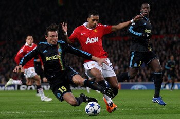 MANCHESTER, ENGLAND - MARCH 15:  Gabriel Heinze (L) of Marseille battles for the ball with Nani of Manchester United during the UEFA Champions League round of 16 second leg match between Manchester United and Marseille at Old Trafford on March 15, 2011 in
