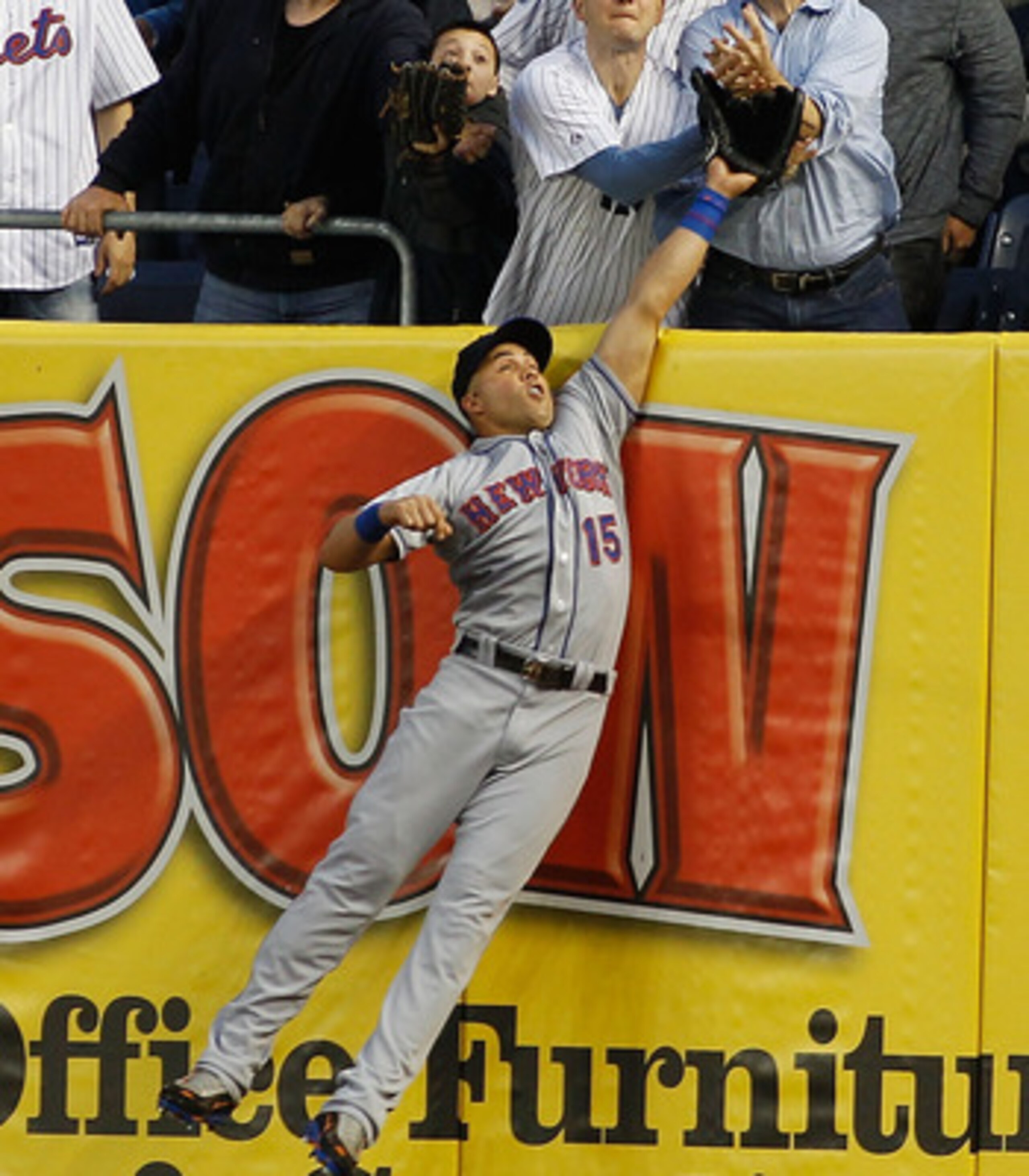 NEW YORK - MAY 20:  Mark Teixeira #25 of the New York Yankees (not pictured) hits a home run just over the leap of Carlos Beltran #15 of the New York Mets in the bottom of the third on May 20, 2011 at Yankee Stadium in the Bronx borough of New York City.