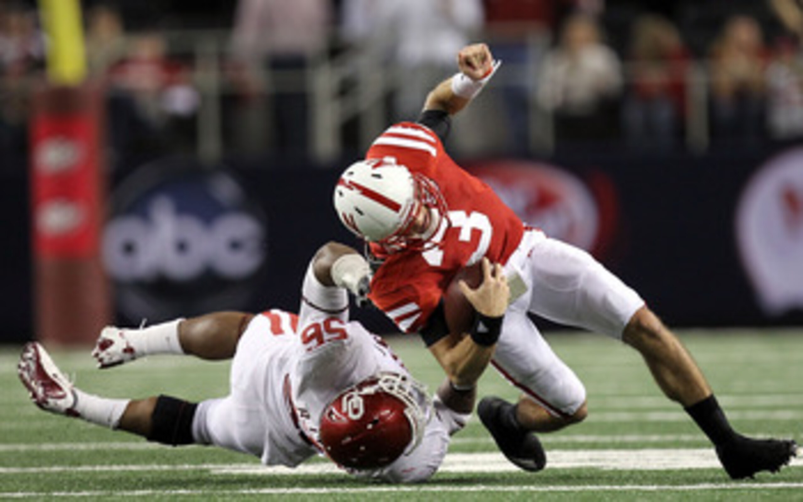 ARLINGTON, TX - DECEMBER 04: Quarterback Taylor Martinez #3 of the Nebraska Cornhuskers is tackled by Ronnell Lewis #56 of the Oklahoma Sooners during the Big 12 Championship at Cowboys Stadium on December 4, 2010 in Arlington, Texas. (Photo by Ronald M ARLINGTON, TX - DECEMBER 04: Quarterback Taylor Martinez #3 of the Nebraska Cornhuskers is tackled by Ronnell Lewis #56 of the Oklahoma Sooners during the Big 12 Championship at Cowboys Stadium on December 4, 2010 in Arlington, Texas. (Photo by Ronald M