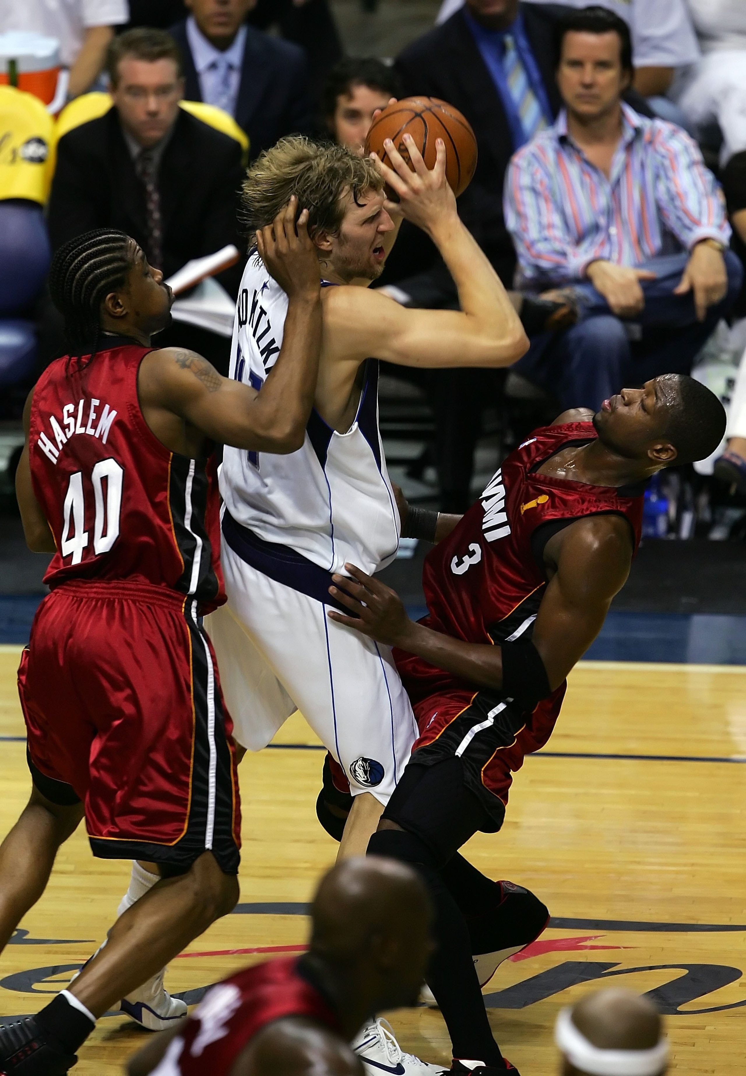 DALLAS - JUNE 08:  Dirk Nowitzki #41 of the Dallas Mavericks crashes into Dwyane Wade #3 of the Miami Heat in game one of the 2006 NBA Finals on June 8, 2006 at American Airlines Center in Dallas, Texas.  NOTE TO USER: User expressly acknowledges and agre