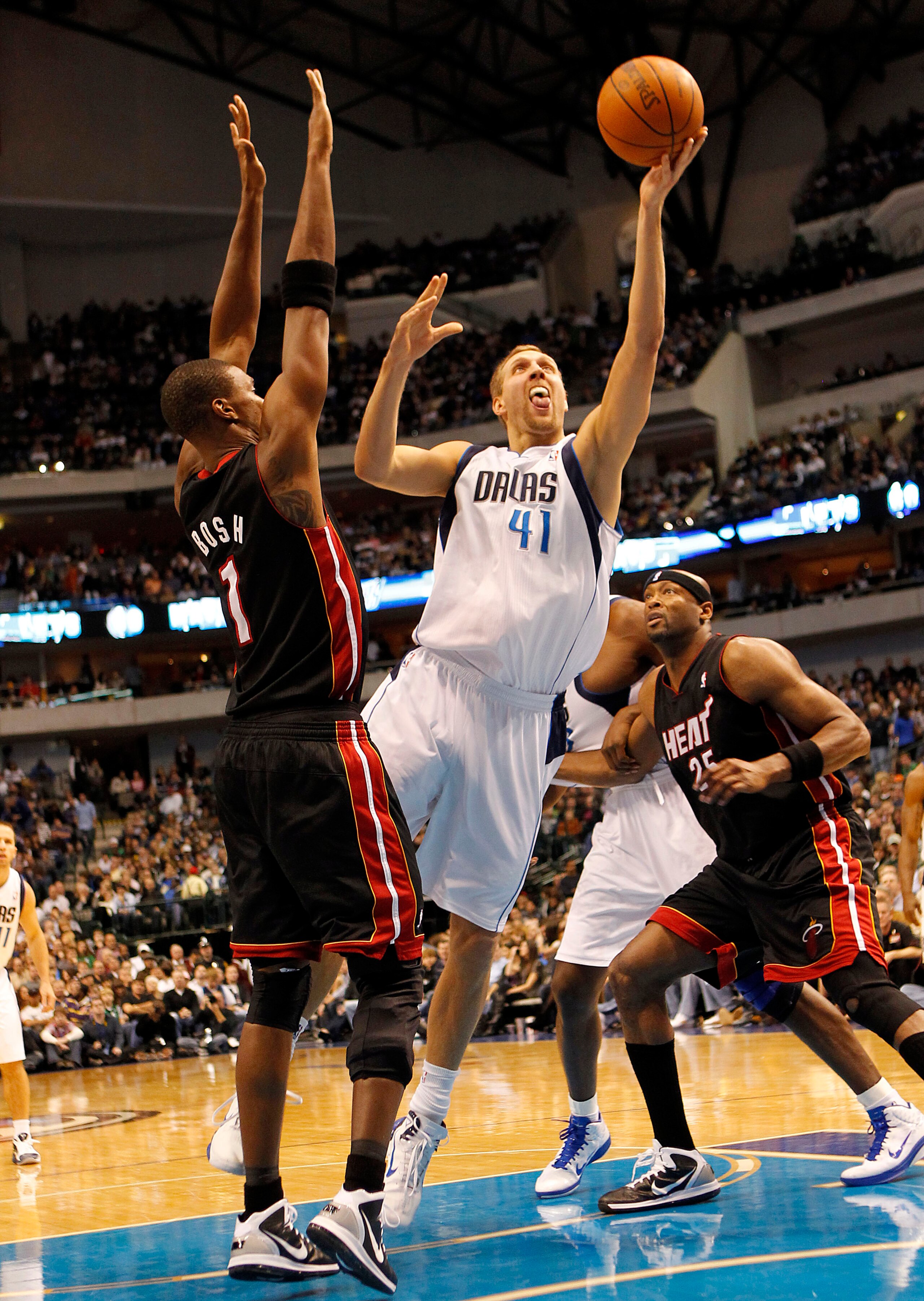 DALLAS - NOVEMBER 27: Dirk Nowitzki #41 of the Dallas Mavericks shoots over Chris Bosh #1 of the Miami Heat on November 27, 2010 at the American Airlines Center in Dallas, Texas. NOTE TO USER: User expressly acknowledges and agrees that, by downloading an