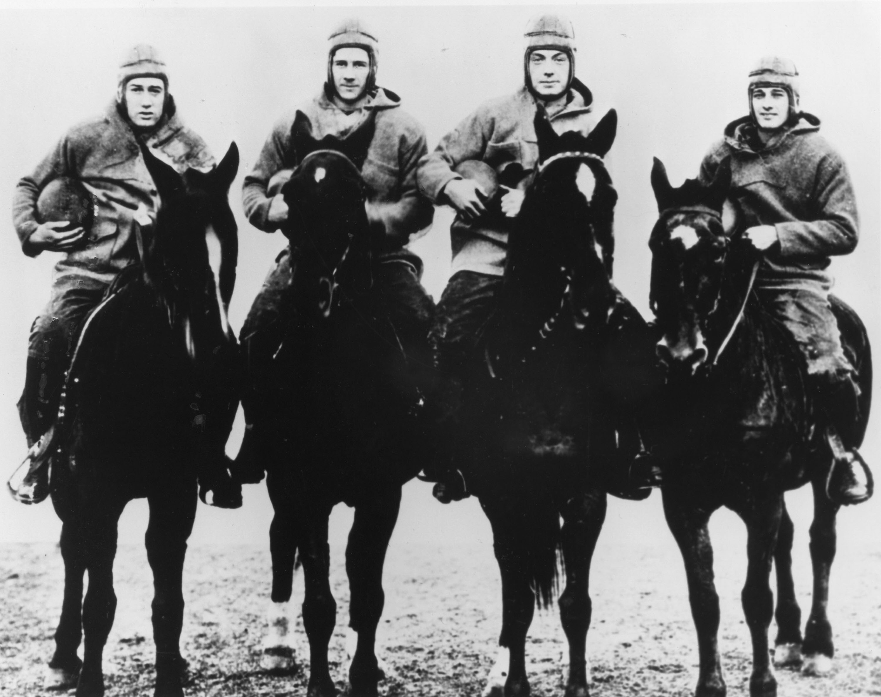 The Four Horsemen of Notre Dame, (L-R) quarterback Harry Stuhldreher, fullback Elmer Leyden, left halfback Jim Crowley, and right hafback Don Miller. George Strickler, Knute Rockne's student publicity aide posed the four players, dressed in their uniforms