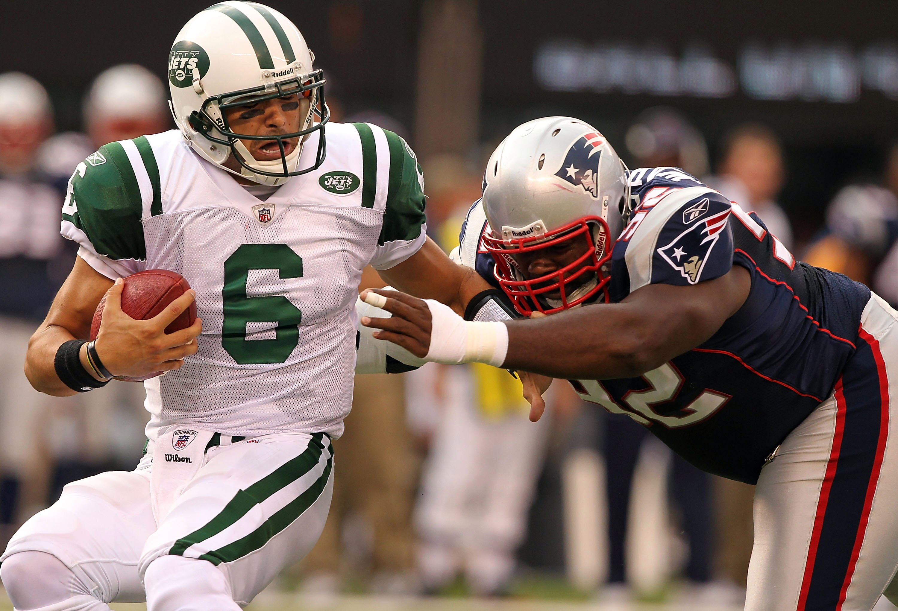 EAST RUTHERFORD, NJ - SEPTEMBER 19:  Mark Sanchez #6  of the New York Jets is sacked by Gerard Warren #92 of the New England Patriots on September 19, 2010 at the New Meadowlands Stadium  in East Rutherford, New Jersey.  (Photo by Al Bello/Getty Images)