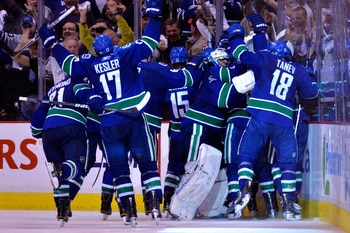 VANCOUVER, CANADA - MAY 24:  Mason Raymond #21, Ryan Kesler #17, Tanner Glass #15, goaltender Roberto Luongo #1 and Chris Tanev #18 of the Vancouver Canucks and their teammates celebrate after they defeated the San Jose Sharks 3-2 in double-overtime in Ga