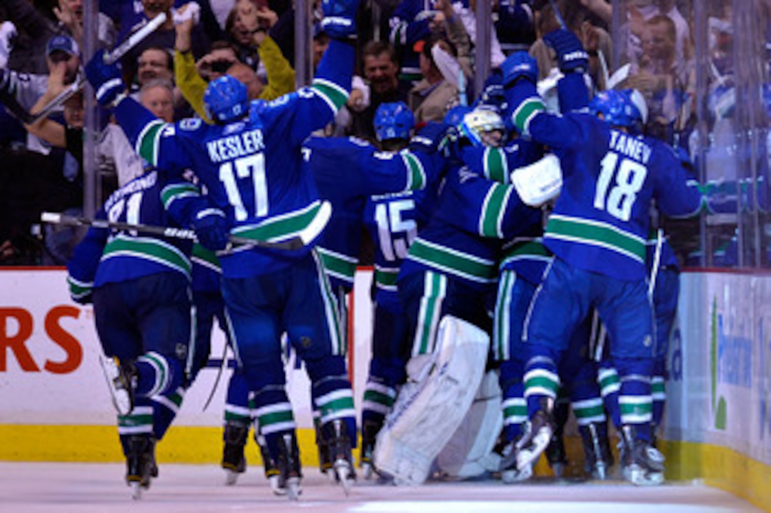 VANCOUVER, CANADA - MAY 24: Mason Raymond #21, Ryan Kesler #17, Tanner Glass #15, goaltender Roberto Luongo #1 and Chris Tanev #18 of the Vancouver Canucks and their teammates celebrate after they defeated the San Jose Sharks 3-2 in double-overtime in Ga VANCOUVER, CANADA - MAY 24: Mason Raymond #21, Ryan Kesler #17, Tanner Glass #15, goaltender Roberto Luongo #1 and Chris Tanev #18 of the Vancouver Canucks and their teammates celebrate after they defeated the San Jose Sharks 3-2 in double-overtime in Ga