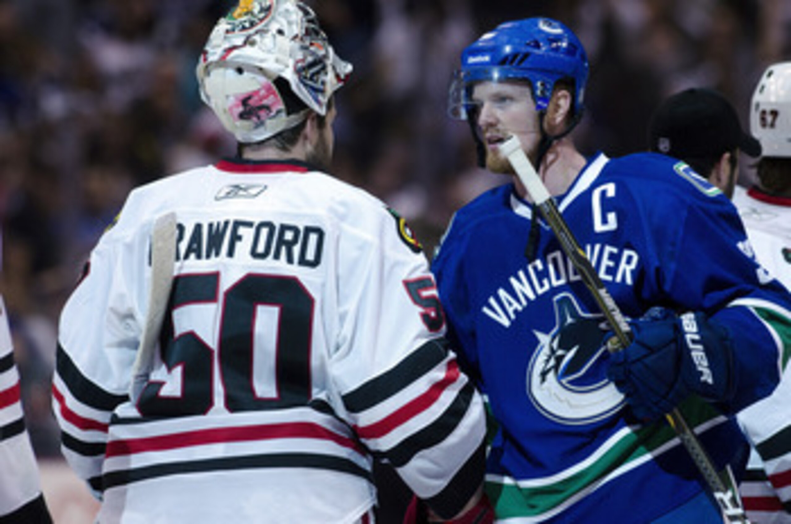 VANCOUVER, CANADA - APRIL 26: Henrik Sedin #33 (R) of the Vancouver Canucks and goalie Corey Crawford #50 of the Chicago Blackhawks shake hands after the Canucks defeated the Blackhawks 2-1 in overtime of Game Seven of the Western Conference Quarterfinals VANCOUVER, CANADA - APRIL 26: Henrik Sedin #33 (R) of the Vancouver Canucks and goalie Corey Crawford #50 of the Chicago Blackhawks shake hands after the Canucks defeated the Blackhawks 2-1 in overtime of Game Seven of the Western Conference Quarterfinals