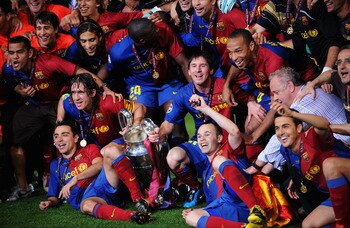 ROME - MAY 27:  Barcelona players pose in front of the trophy after they celebrate winning the UEFA Champions League Final match between Barcelona and Manchester United at the Stadio Olimpico on May 27, 2009 in Rome, Italy. Barcelona won 2-0.  (Photo by S
