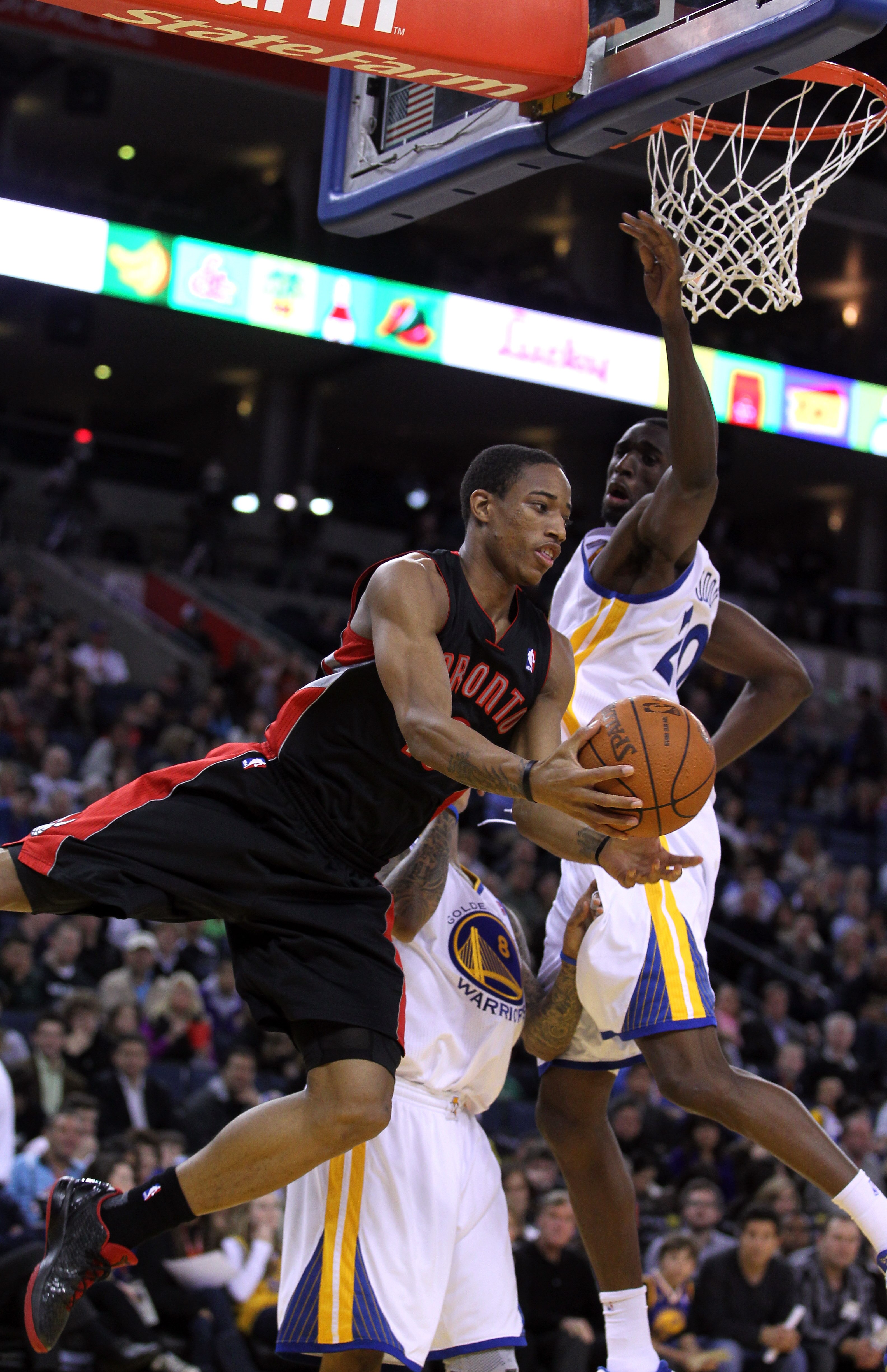 OAKLAND, CA - MARCH 25: DeMar DeRozan #10 of the Toronto Raptors drives around Ekpe Udoh #20 of the Golden State Warriors at Oracle Arena on March 25, 2011 in Oakland, California. NOTE TO USER: User expressly acknowledges and agrees that, by downloading a OAKLAND, CA - MARCH 25: DeMar DeRozan #10 of the Toronto Raptors drives around Ekpe Udoh #20 of the Golden State Warriors at Oracle Arena on March 25, 2011 in Oakland, California. NOTE TO USER: User expressly acknowledges and agrees that, by downloading a