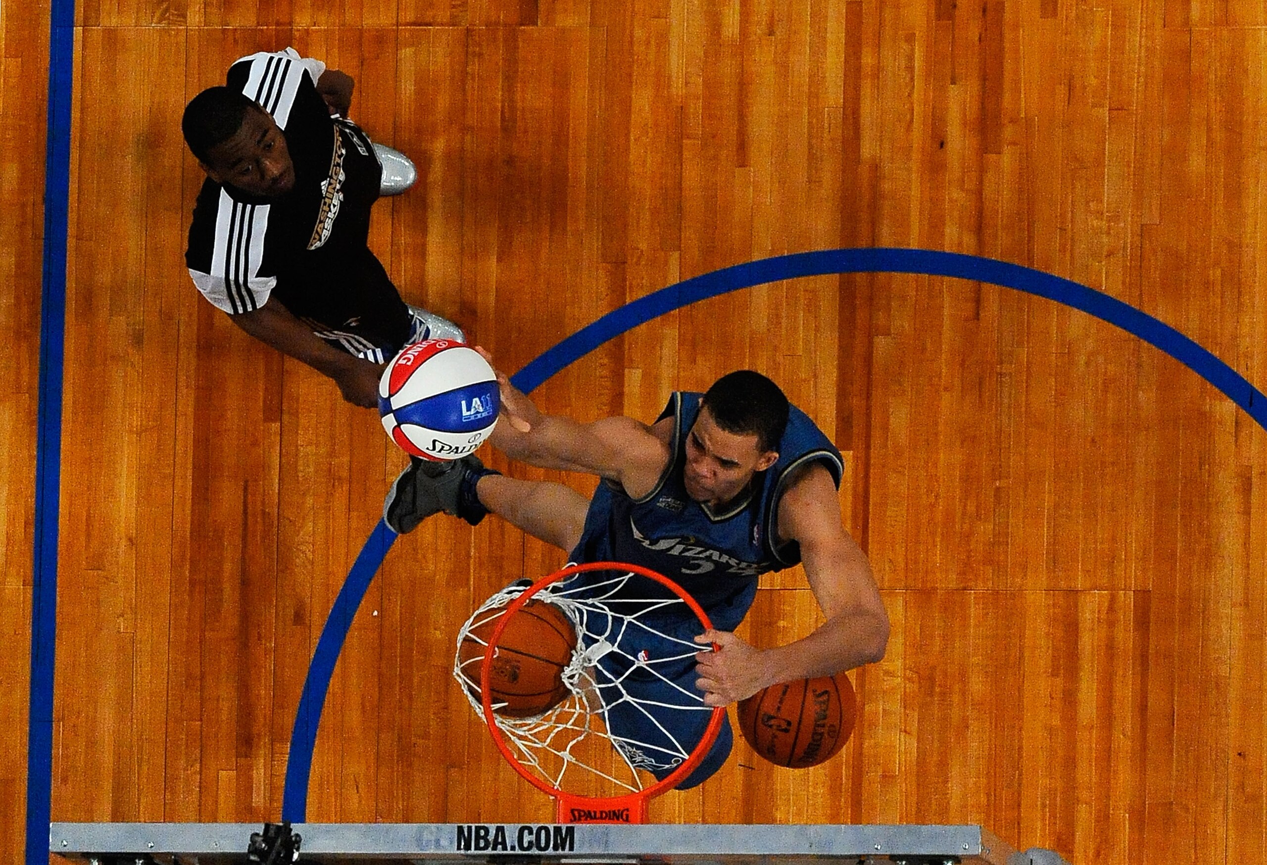 LOS ANGELES, CA - FEBRUARY 19:  JaVale McGee #34 of the Washington Wizards dunks three balls on the same jump after a pass from teammate John Wall #2 in the second round of the Sprite Slam Dunk Contest apart of NBA All-Star Saturday Night at Staples Cente