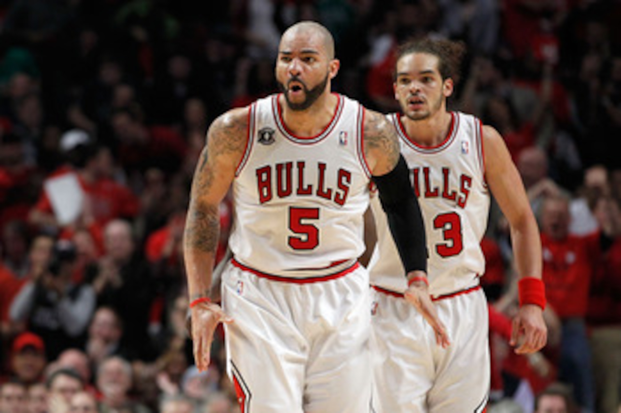 CHICAGO, IL - MAY 15:  Carlos Boozer #5 and Joakim Noah #13 of the Chicago Bulls react against the Miami Heat in Game One of the Eastern Conference Finals during the 2011 NBA Playoffs on May 15, 2011 at the United Center in Chicago, Illinois. NOTE TO USER
